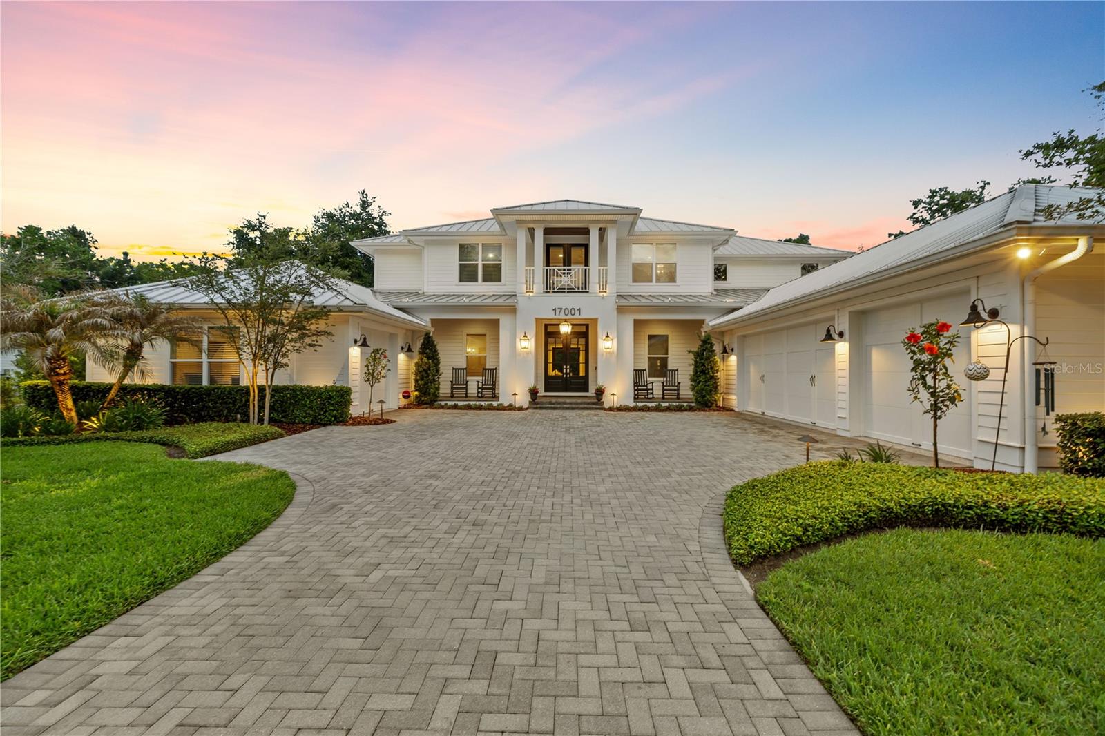 An exceptional opportunity to own a private, custom-built estate in one of Lutz’s most exclusive gated enclaves, this Bayfair-built residence offers a rare blend of luxury, space, and convenience just minutes from I-275. Situated on approximately 1.17 acres with an additional adjoining conservation parcel, the property provides a true sense of privacy with breathtaking views. Built in 2020 and spanning over 5,200 square feet under air, the home showcases engineered hardwood flooring throughout, extensive custom millwork, beam details, and abundant natural light that highlights the level of craftsmanship throughout. Designed for both everyday living and elevated entertaining, the open-concept layout is anchored by a chef’s kitchen featuring honed marble countertops, a full Thermador appliance package including double ovens, and an expansive butler’s kitchen complete with beverage center, ice maker, built-in coffee system, and a separate walk-in pantry. The main level features a spacious primary suite with dual walk-in closets and a well-appointed bath, along with an additional first-floor en suite with private patio overlooking the conservation. Upstairs offers additional bedrooms, a reading loft, media room with built-in bar, and two private balconies overlooking the preserve, along with a secondary laundry closet complementing the oversized main laundry room. Outdoor living is thoughtfully designed and truly sets the home apart, featuring a heated saltwater pool with a 10-person spa, expansive screened lanai, fully equipped outdoor kitchen, outdoor fireplace, private putting green, and a dedicated herb and vegetable garden, all positioned to take full advantage of the surrounding natural setting. Additional highlights include a 4-car garage, standing seam metal roof, two tankless water heaters, whole-house generator with 1,000-gallon propane tank, Control4 smart home automation managing lighting, security, audio/video, and climate, and a 13-zone irrigation system. A truly turnkey, luxury estate offering privacy, space, and convenience in one of Lutz’s most desirable locations. Call for your private appointment today!