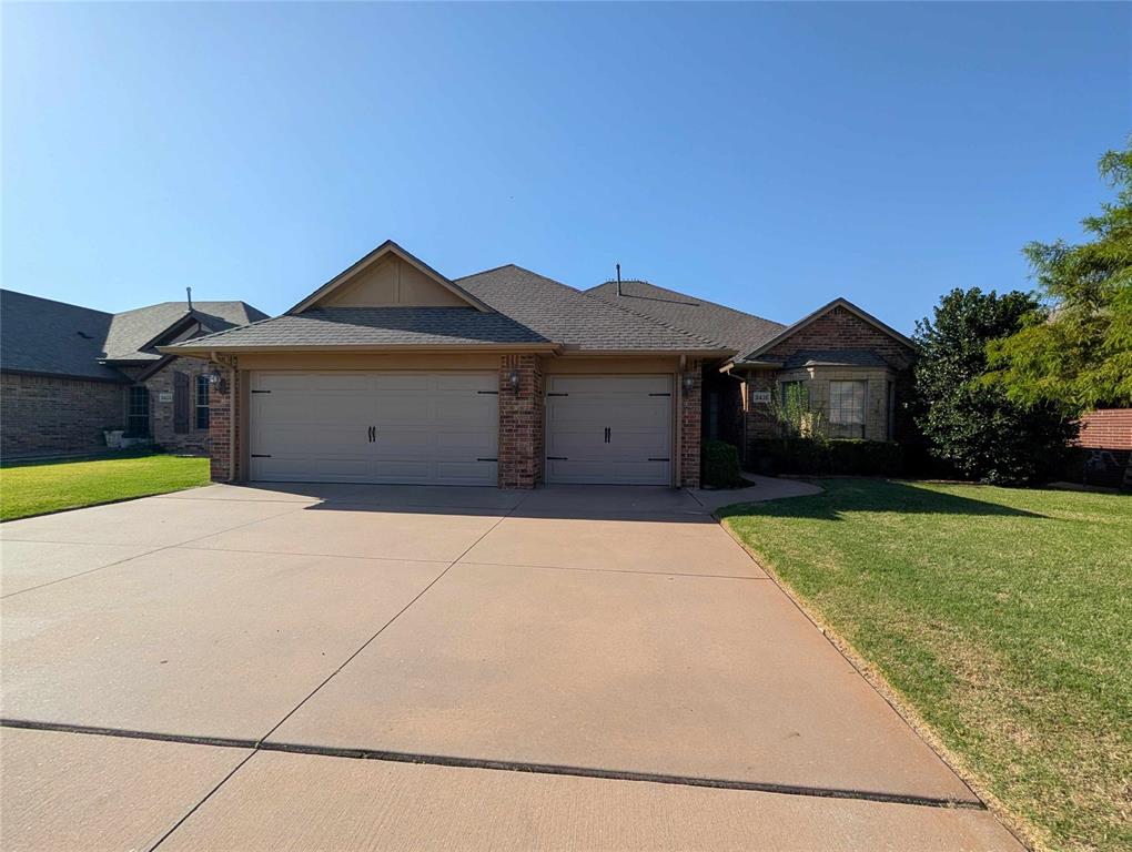 This beautiful home offers a spacious layout with stylish details throughout. The living area features wood-look flooring, crown molding, and a brick fireplace, opening into the dining area and kitchen. The kitchen includes granite countertops, rich wood cabinetry, stainless steel appliances, a gas range, tiled backsplash, and breakfast bar. The spacious primary suite features a tray ceiling and a private bathroom with a jetted tub, tiled walk-in shower, and large walk-in closet. Additional highlights include comfortable secondary bedrooms, plenty of storage, and an attached three car garage. Schedule your private showing today!