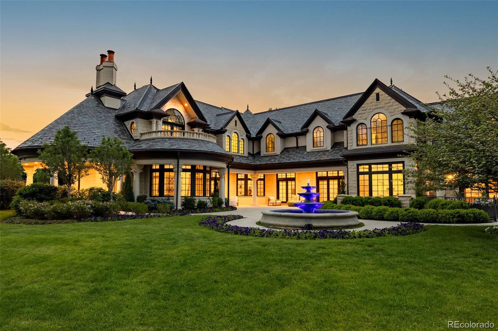 Located within the prestigious, guard-gated Cherry Hills Park community, this exceptional estate offers timeless elegance, privacy, and refined luxury on approximately 2.4 acres of beautifully landscaped grounds. Designed for both grand entertaining and comfortable everyday living, the residence spans roughly 12,075 square feet and includes 5 bedrooms, 8 bathrooms, and two 2-car garages connected by handsome porte-cochere.The home features a thoughtfully designed floor plan with formal living and dining rooms, inviting gathering spaces, and seamless indoor-outdoor connections. A standout upgrade is the custom Mick De Giulio gourmet kitchen, including one-of-a-kind German pounded silver hood and hardware plus elegant gold leaf cabinetry, combining quality craftsmanship with high-end appliances and functional beauty. The primary suite is a private retreat with a spa-inspired bath and dual custom closets, while secondary bedrooms are generously sized with en-suite baths. Additional interior highlights include vaulted ceilings, a flexible upper-level loft space, and beautifully appointed finishes throughout.  A hydraulic elevator servicing all three levels adds convenience and accessibility.Designed for lifestyle and wellness, the home includes an indoor putting green with precise two-degree slope, fully equipped fitness center with custom built, infrared sauna, and multiple entertainment spaces. Outdoor amenities are equally impressive, featuring multiple lush gardens, fountains, a bocce ball court, hot tub, and expansive patios ideal for hosting gatherings or enjoying peaceful evenings.Recent and notable upgrades include an integrated state-of-the-art security system, extensive custom millwork, refined architectural details, and meticulously maintained landscaping. Combining classic architecture with modern luxuries, this rare Cherry Hills Village estate offers an unparalleled living experience in one of Colorado’s most coveted neighborhoods.