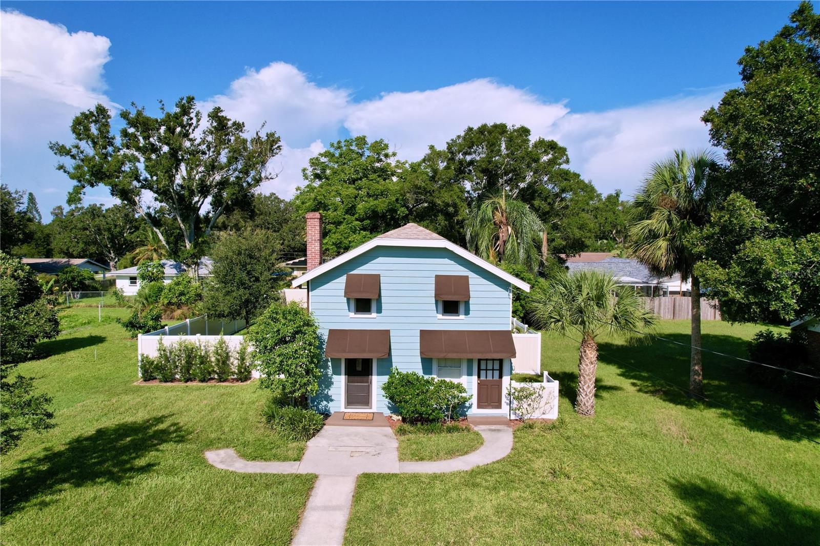 Charming with Vintage Character and Well Cared for Home on .26 acres.  Original Hardwood floors upstairs, pre-war glass window panes, original brick fireplace behind wall in living room.  Fresh Paint inside and outside. Water Heater 6 years old.  New blinds. Newer Electrical.  A/C 4 years old. Upstairs Bath remodeled.  New Vinyl Fence.  New Awnings front and back. Recessed lighting in Kitchen. Refurbished interior Doors.  Roof under 10 years old.  New Washer.  Pantry under stairs.  New shell driveway.  Home is setback approximately 100 ft from the street offering privacy  Huge private vinyl fenced backyard with a 462 sf detached workshop that can easily be converted into a studio, in law quarters, office, etc.  New raised composite deck in back for enjoyable relaxation.  Located in the heart of Largo's Old Northwest, Centrally located to Largo Central Park, Bus Lines, Restaurants, Shopping, and minutes to our Beautiful Sandy Beaches.