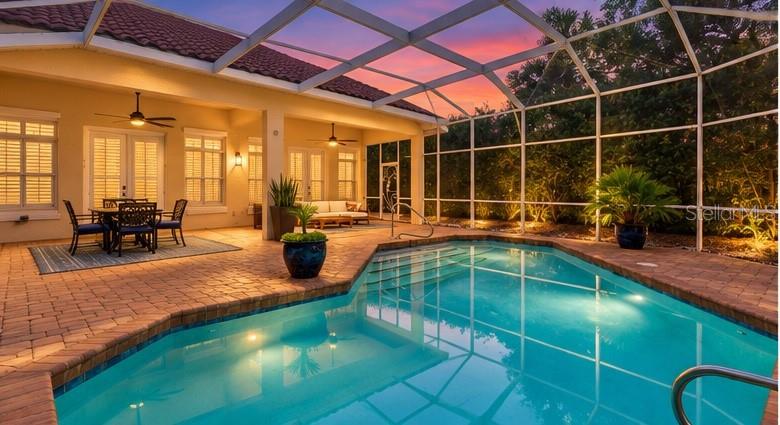 Virtually Staged. Experience refined coastal living in this beautifully appointed pool home located within the prestigious gated oceanfront community of Hammock Dunes. Nestled on a quiet street, this elegant residence offers an ideal blend of timeless design, comfortable living, and effortless indoor-outdoor entertaining. The spacious open-concept floor plan features soaring ceilings, abundant natural light, and a striking floor-to-ceiling stone fireplace that serves as the focal point of the main living area. The gourmet kitchen is designed to impress with custom cabinetry, granite countertops, a large center island with prep sink, stainless steel appliances, double wall ovens, and generous workspace perfect for everyday living or entertaining.Ideal layout features the primary suite, kitchen, dining and living areas on the ground level. Magnificent pool and patio area, convenient full pool bathroom off garage. Fenced-in yard with plenty of room for young ones or a furry friend to roam. The expansive covered lanai creates a true outdoor retreat overlooking the screened pool  (a convenient pool bath located off of the garage) and private backyard, complete with multiple seating areas, ceiling fans, and seamless access from the home's living spaces. The spacious primary suite provides a peaceful escape, while thoughtfully designed guest accommodations offer comfort and privacy for family and visitors.Located in one of Palm Coast's most sought-after luxury communities, residents enjoy 24-hour gated security, beautifully maintained surroundings, and optional membership opportunities at the renowned Hammock Dunes Club featuring championship golf, oceanfront dining, fitness facilities, tennis, pickleball, croquet, and private beach access. Just minutes from shopping, dining, marinas, and all that Palm Coast has to offer, this exceptional home presents the perfect opportunity to enjoy Florida's premier coastal lifestyle.
