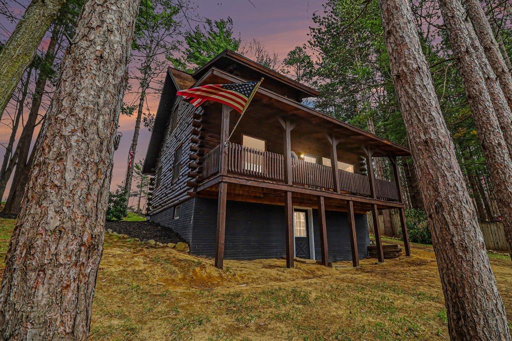 Escape to this fabulous log home offering the perfect blend of rustic charm and serene waterfront living. Step inside to an inviting open floor plan highlighted by soaring cathedral ceilings and a stunning staircase that adds to the home's character. The loft-style bedroom features a charming dormer window, creating a cozy retreat with a view.Beautiful details like a stained glass window add warmth and uniqueness, while the covered deck provides the perfect spot to relax and take in peaceful waterfront views. Nestled in a quiet, wooded setting on a no-wake lake, this property offers tranquility along with access to multiple connected lakes--ideal for fishing and exploring.The heated walkout basement adds extra living space and flexibility, making this home as functional as it is picturesque.
