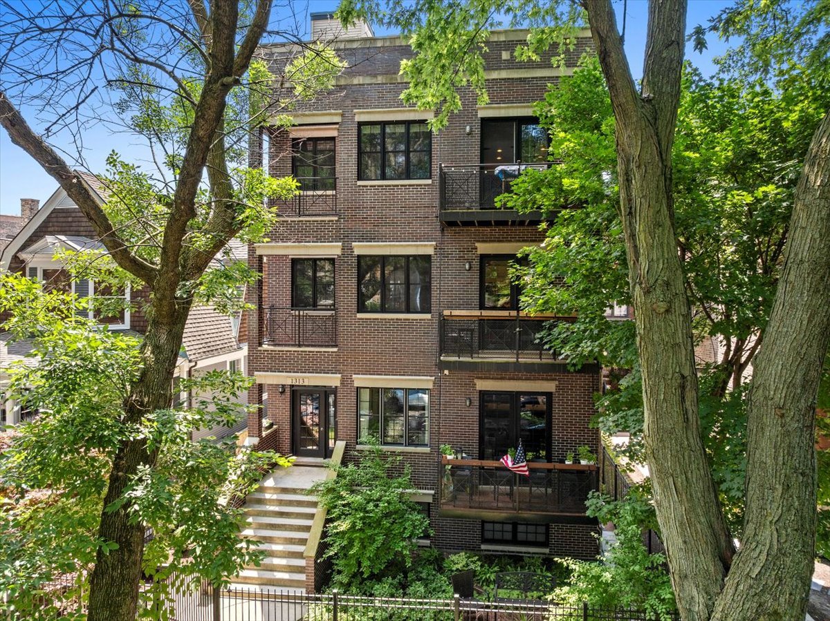 Located in Uptown and near the heart of Andersonville, this two-level duplex has a practical layout with generous space on both floors with 10-foot ceilings. The main level has a beautifully updated kitchen with large windows, custom cabinetry, stainless steel appliances, and a Wolf range with vent hood. There's seating at the island for four and a clear flow into the living and dining areas, making it easy to entertain or relax. The living room sits on a corner with abundant natural light, a fireplace, and the dining area connects seamlessly to the kitchen and living room. Just off the living room space, there's access to a large private deck, offering room for outdoor dining or lounging. Bedrooms are positioned on a separate floor for added privacy. Each includes a walk-in closet with built-in organization and oversized windows. Bathrooms have been modernized with clean, updated finishes. The home also has updated lighting throughout, a separate storage unit, in-unit washer and dryer, and one parking spot. This is one of five units in a professionally maintained building. The location is ideally positioned between Broadway and Clark, with a variety of restaurants and shops just a 5-minute walk in either direction. The Argyle Red Line station is also about a 5-minute walk. Jewel-Osco and Mariano's are approximately a 10-minute walk, and the lakefront and Foster Beach are a 5-minute drive.