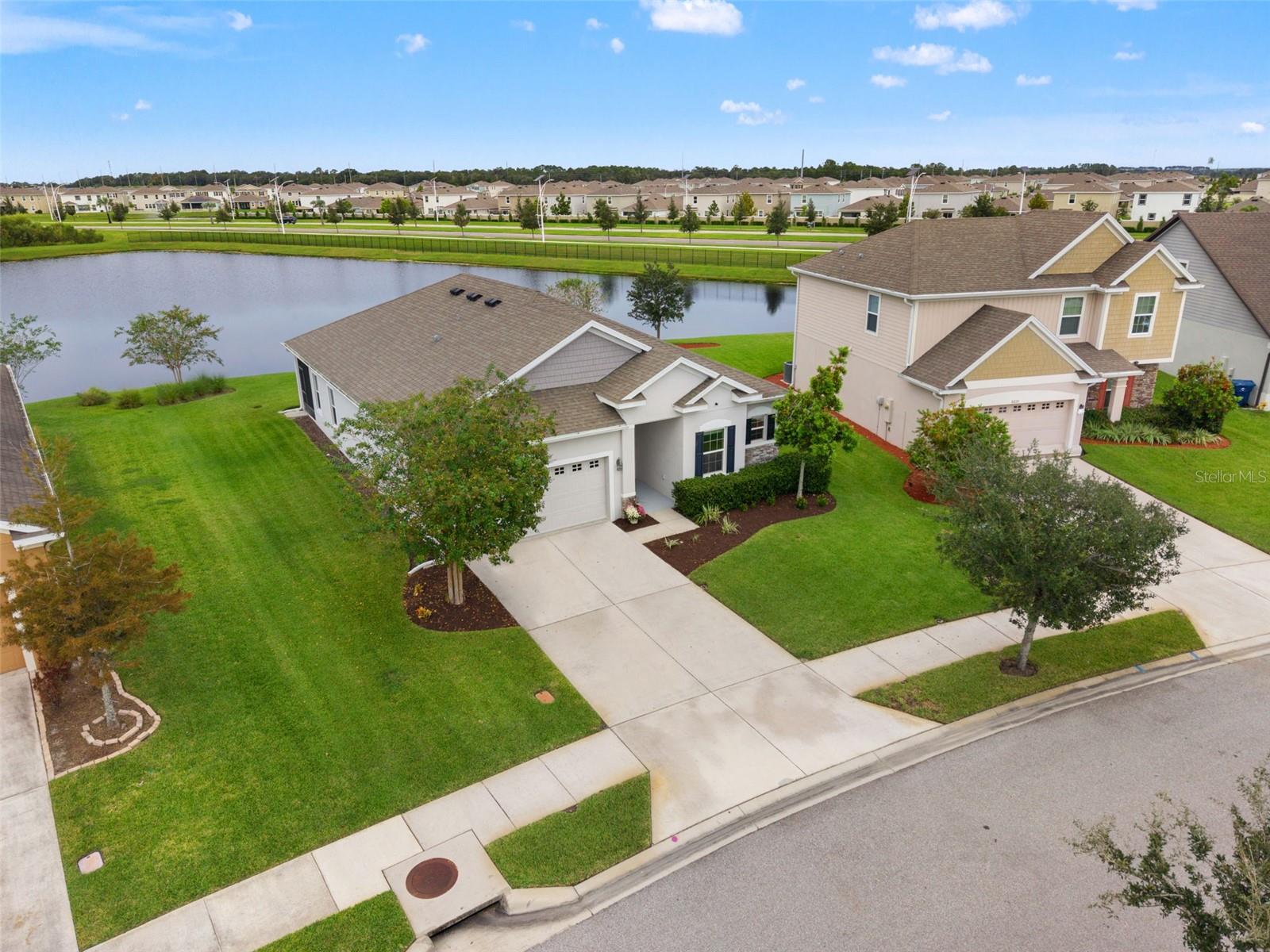 Wake up to pond views in this 1-story picturesque home with an Assumable VA Home Loan (yes, Buyers can assume the current loan).Welcome to 8232 Olive Brook Drive. This 2018 Maronda home sits on a tranquil street inside the gates of Epperson Ranch South, one block from the Epperson Crystal Lagoon. It has 3 bedrooms, 2 baths and 1,998 heated square feet, all on one level, and the backyard opens onto a peaceful pond with no rear neighbors.You’ll see why this home stands out as soon as you walk in. Luxury vinyl plank runs throughout, crown molding frames the open great room, and the oversized granite island seats four with room to spare. White shaker cabinets reach up to the crown, three polished pendants hang over the island, and a glass and stone mosaic backsplash ties it all together. Puck lights under the cabinets add a warm glow at night. The cook in your life will love the built-in double wall oven and separate cooktop, an upgrade over the standard range. The refrigerator has its own hot water dispenser and a built-in Keurig brewer, so the morning coffee run happens without leaving the kitchen.The primary suite is a retreat of its own. The bath has a freestanding soaking tub under a window that looks out on the pond, a walk-in tiled shower with a rain head, and a dual vanity with a makeup station. Built-in shelving, drawers and lighting fill the primary walk-in closet.Updates made in 2024 include a new water heater, microwave, smart thermostat and exterior coach lights. Security cameras give you peace of mind. The block and stucco construction sits in flood zone X. The sellers will include the golf cart with a good offer, so you can zip over to the Lagoon in minutes.Living in Epperson means resort living without leaving home. The Crystal Lagoon has white sand beaches, a swim-up area, an inflatable water park, cabanas, a waterslide, volleyball courts, and dining and events on site. This is a charter home in gated Epperson South, so the fees are lower than at non-charter homes in Epperson North and Epperson II. The HOA is just $261 per quarter and includes cable and high-speed internet. The Lagoon fee is only $117 per quarter.You’ll be minutes from I-75 and close to the shopping, dining and medical centers along the SR 56 corridor, with Tampa Premium Outlets, the Shops at Wiregrass, AdventHealth, BayCare and the upcoming John Hoskins Hospital, all nearby. Schools are Wesley Chapel Elementary, Thomas Weightman Middle and Wesley Chapel High.Tours are available 7 days a week. Come see the pond views and the Lagoon lifestyle in person. There's a video tour on YouTube, just search by address. The Seller's Preferred lender is offering up to $5,000 towards the Buyers Closing Costs for a limited time. Restrictions apply.