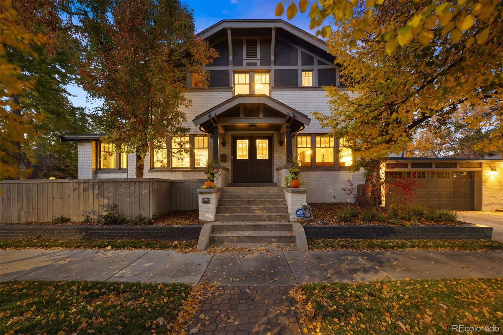Timeless character meets modern comfort in this beautifully updated two-story craftsman-style home on a picturesque tree-lined street in Denver’s Congress Park.  Brimming with natural light from numerous windows, this expansive 5 bed, 5 bath home has been extensively updated over the last 5 years.  Enjoy the open floor plan, spacious dining room, 2 fireplaces, inviting sun-room, 2 primary suites, 2 kitchens and 2 separate private fenced yards…one with a tremendous swim spa!  The private 1 bedroom apartment is perfect for a teen or the in-laws, or as a cash-generating short-term vacation rental!  The home has hardwood floors throughout and is ideal for entertaining family and friends. The remodeled kitchen features granite counters, high-end stainless appliances including a 36” gas range and wine refrigerator.  A striking 19th-century hand-carved Indian door leads to an oversized pantry.  Upstairs, the serene primary suite includes two walk-in closets and you’ll really enjoy having the convenience of laundry on the upper level.  The updated and finished lower level offers exceptional versatility with a wet bar, cozy library with secret bookshelf doors, and a guest suite with fireplace and a walk-in closet. A rare attached two-car garage connects to a spacious mudroom with heated floors and custom storage, while a bonus suite above the garage provides an ideal office and/or guest space.  Outside, enjoy the fully fenced, low-maintenance yard featuring premium turf, new fencing, and a rebar-reinforced stamped concrete patio—perfect for outdoor dining and relaxation.  With a walk score of 71 “very walkable” you’ll love living just blocks from the new Congress Park Pool and steps from so many of Denver’s top restaurants, shops and grocery options. Only 5 minutes on foot to Cherry Creek North!  This extraordinary home blends historic soul, modern design, and unmatched livability in one of the city’s most cherished in-town neighborhoods.