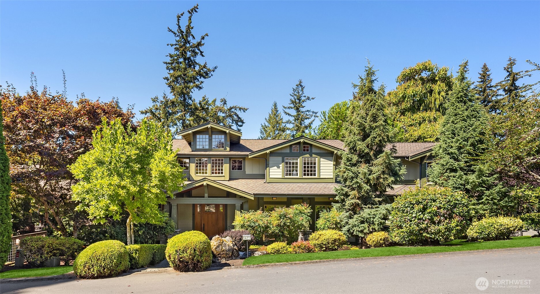 Rarely does a home of this caliber come to market. Sited on a 17,920 Sq. Ft. lot and a stone's throw from LK Washington and Kiwanis Park-this significant California Craftsman was designed for gathering and entertainment. The two-story great room has exposed timber trusses rising overhead. Warm earth-tone palettes mimic the interiors in the Craftsman tradition, while art glass specified lighting brings warmth and color to every room. Woodwork of this intricacy is stunning and is the home's signature-from the commanding staircase to rows of custom built-ins to hallways that stop guests in their tracks. Scale and craftsmanship are seldom found, and rarer still in today's builds. The kitchen responds to serious chefs: a 48" Fulgor Milano induction range, a Tulikivi wood-fired pizza oven; Miele, Viking, and Thermador appliances throughout. A sunlit breakfast nook overlooks south lawn+gardens. Two main-floor offices. A bonus room on both the main and upper level gives everyone somewhere to land. The primary suite encompasses the entire south wing. Two additional bedrooms share a Jack-n-Jill bath. Fourth bedroom ensuite has its own sitting area and a dedicated home gym completes this level. A 2100+Wine Celler commands lower level. Outdoor kitchen and patio is highlighted by meticulously designed gardens, greenery and level yard. Walk to DT Kirkland, Shopping and Restaurants. Inquire about separate tax parcel-behind the home with more than $250,000 invested in park like landscaping.