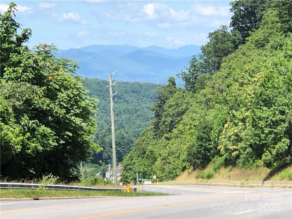 In Biltmore Township bordering Fairview Township..  Located on 5 lane Hwy 74A Scenic Highway and Cedar Mountain Road. 3 miles to I 40, I 240, Blue Ridge Parkway & Asheville. Total of 1800 feet of road frontage (900 feet on Hwy 74A, 600 feet on Cedar Mountain Road and 300 feet on Atherton. Public water with fire hydrants on all three roads. Public sewer with 97,500 gallons per day allocation for 250,000 sf of commercial and 800 bedrooms, gas, electric, cable phone on prime corner location at the top of Minehole Gap with over 20,000 cars per day.  Double access curb cut on 5 lane Hwy 74A. Long range views. Previously under contract for $1,100,000 for assisted living facility. Owner Broker would consider joint venture.