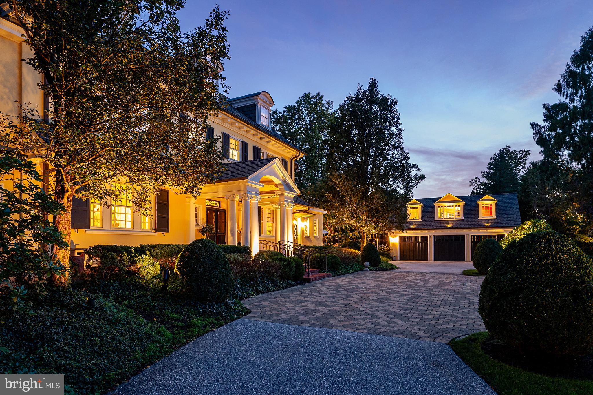 612 Winsford Road presents a rare opportunity to own a truly distinctive Bryn Mawr estate, combining classic Main Line architecture, exceptional interior design, expansive grounds, and resort-style amenities on approximately 1.2 beautifully landscaped acres. Enjoy the convenience of walking into Bryn Mawr for dinner, a movie, or the train to Center City, as well as nearby Merion Cricket Club, Haverford Square, and Suburban Square—all connected by sidewalks.Approached through stone entrance pillars and surrounded by mature specimen landscaping, the property offers exceptional privacy and presence. Sweeping level lawns, formal gardens, an ornamental water feature, extensive landscape lighting, a private swimming pool and pool house, and a separate carriage house create a remarkable estate setting.The residence has been extensively transformed through two significant renovations led by accomplished designers. The interiors honor the home's architectural heritage while introducing a sophisticated, highly individual aesthetic. Venetian plaster, custom wallcoverings, detailed millwork, bespoke cabinetry, designer lighting, radiant-heated flooring, high-end fixtures, and carefully selected finishes are found throughout.A gracious center hall introduces dramatic craftsmanship and a sweeping staircase. The elegant living room is anchored by a striking custom Grigio Dark Onyx fireplace surround, while the formal dining room and additional living spaces offer an effortless flow for entertaining.A spectacular custom bar and lounge features dark lacquered millwork, built-in cabinetry, banquette seating, and bespoke finishes. A private office and additional sound-insulated conservatory provide flexible spaces for work, creative pursuits, or a quiet retreat.The beautifully designed kitchen features marble countertops, abundant cabinetry, a substantial center island, and high-end appliances. It opens to a light-filled breakfast room wrapped in black-framed windows with custom banquette seating and direct access to the pool and gardens. An adjoining family room with fireplace, custom millwork, and garden views creates an inviting everyday gathering space.The expansive primary suite is a true retreat, featuring a fireplace framed in Grigio Carnico marble, multiple adjoining spaces, substantial custom dressing rooms, and a beautifully appointed marble bath with dual vanities, soaking tub, oversized glass-enclosed steam shower, radiant heat flooring and extensive built-in storage. Additional bedrooms and baths continue the home's distinctive design with custom wallcoverings, built-ins, millwork, and individually designed finishes.The third floor offers flexible recreation, guest, and additional living spaces with laundry and bath facilities. The finished lower level provides multiple media and play areas and offers potential for an in-law or au pair suite.Beyond the main residence, the carriage house/garage includes a private apartment with its own living area, kitchenette, fireplace, bedroom, and bath—ideal for guests, a private office, or additional residential use.Outdoors, mature trees and layered landscaping surround broad lawns, formal gardens, and a private pool and pool house, creating the scale and versatility of a private compound in the heart of Bryn Mawr.The current owners have made substantial investments throughout the property, including exterior and mechanical improvements, pool upgrades, landscaping and irrigation, landscape lighting, security enhancements, and extensive interior improvements. The home's extraordinary transformation was also prominently featured in Philadelphia magazine.612 Winsford Road is a singular Main Line estate offering exceptional architecture, design, privacy, and indoor-outdoor living in one of Bryn Mawr's most desirable settings.