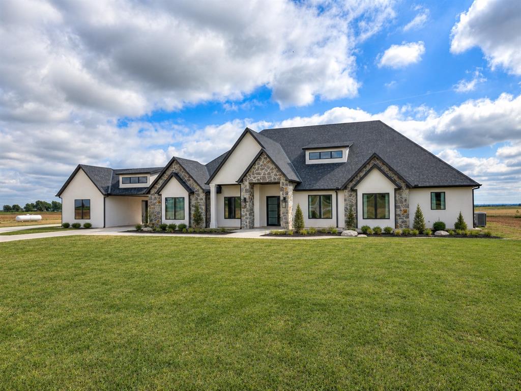 Modern Luxury on 10 Private Acres Stunning 4 bed, 4.1 bath custom home featuring a light-filled open layout and a show-stopping kitchen with oversized island and walk-in pantry. Thoughtfully designed with a private office, safe room, spacious laundry, and a luxurious primary suite with spa-like bath and massive closet.Enjoy outdoor living on the expansive covered patio overlooking your private acreage. Includes a 4-car garage and a 3,600 sq ft insulated shop with covered porch—perfect for hobbies, business, or storage.High-end finishes, space, and privacy—this one truly has it all.
