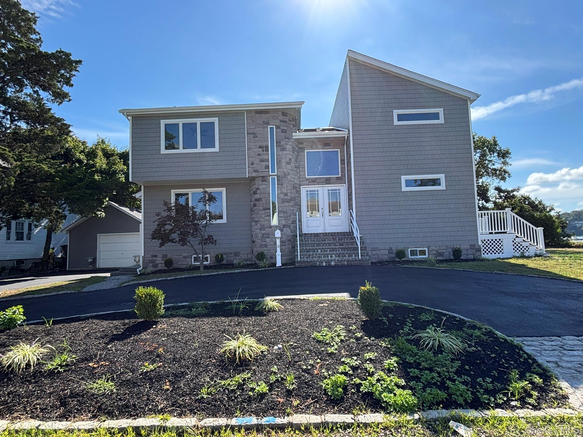 welcome to this waterfront contempary colonial,fully renovated. this bayside waterfront home has incredible views .great room has full wall of new sliders overlooking water,new trex decking from first an second floor decks ,great room features beautiful stone fireplace. gorgeous new kitchen with center island,white shake cabinets,quartz contertops, new high end appliances.1st floor has lovely french doors to den.half bath.second floor has 4 large bedrooms.master bedroom vaulted ceiling wall of glass overlooking waterfront,door leads out to private deck. master bath vaulted ceiling , huge seperate shower , soaking tub,double sinks.space age toilet.recessed lighting throughout ,high tech ceiling fans,radiant heat in several rooms,has seperate guest space,new stone front,all new siding an new roof,circular driveway newly blacktop 2nd floor laundry room,so many extras stunning waterfronthome