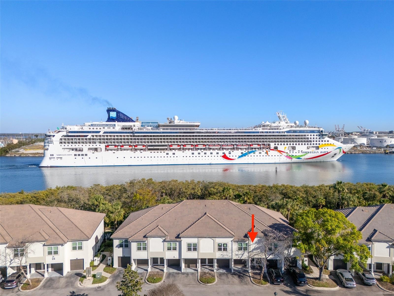 Experience the pinnacle of waterfront living in the most desirable location within the gated Island Walk community. This sophisticated two-story executive condo offers a rare architectural layout featuring twelve-foot vaulted ceilings, a premium detail available in only a select few units throughout the complex. The seller is providing an exceptional financial incentive by paying off all existing assessments at the time of closing.The interior has been meticulously updated with a premium level four finished drywall on all walls and ceilings, complemented by solid core five-panel doors, updated fixtures, switches, outlets and a high-efficiency Trane air conditioning system. On the main living level, the open floor plan is illuminated by upgraded Phillips LED track lighting, natural light beaming through the sliding glass doors, and features a gourmet kitchen equipped with stainless steel LG and Bosch appliances. Bedroom windows are hurricane impact windows and newer hot water heater. The spacious family room offers stunning views of the Sparkman Channel, providing a front-row seat to passing cruise ships. Residents can enjoy the Florida breeze by opening the wall-to-wall sliders that lead to a private, fully screened-in balcony.The residence includes a primary suite with a private en-suite bathroom, walk-in closet, and ample natural light. The large second bedroom offers a large closet, easy access to a full hall bath, and the unit features a private lower-level enclosed garage with interior access. Residents enjoy an active lifestyle with an array of amenities covered by HOA fees, which include building flood insurance, water, twenty-four-hour security, and twice-weekly concierge trash pickup. On-site facilities include a community pool, tennis courts, playground, and a fitness center.All exterior renovations for this building have been completed, ensuring a move-in-ready experience. This prime location puts you within a mile-walking distance to Tampa’s premier destinations, including Sparkman Wharf, Water Street, the Tampa Riverwalk, and Benchmark International Arena, as well as Greenwise Publix and several Michelin Star restaurants. This is your opportunity to purchase a slice of heaven with plenty of upside.