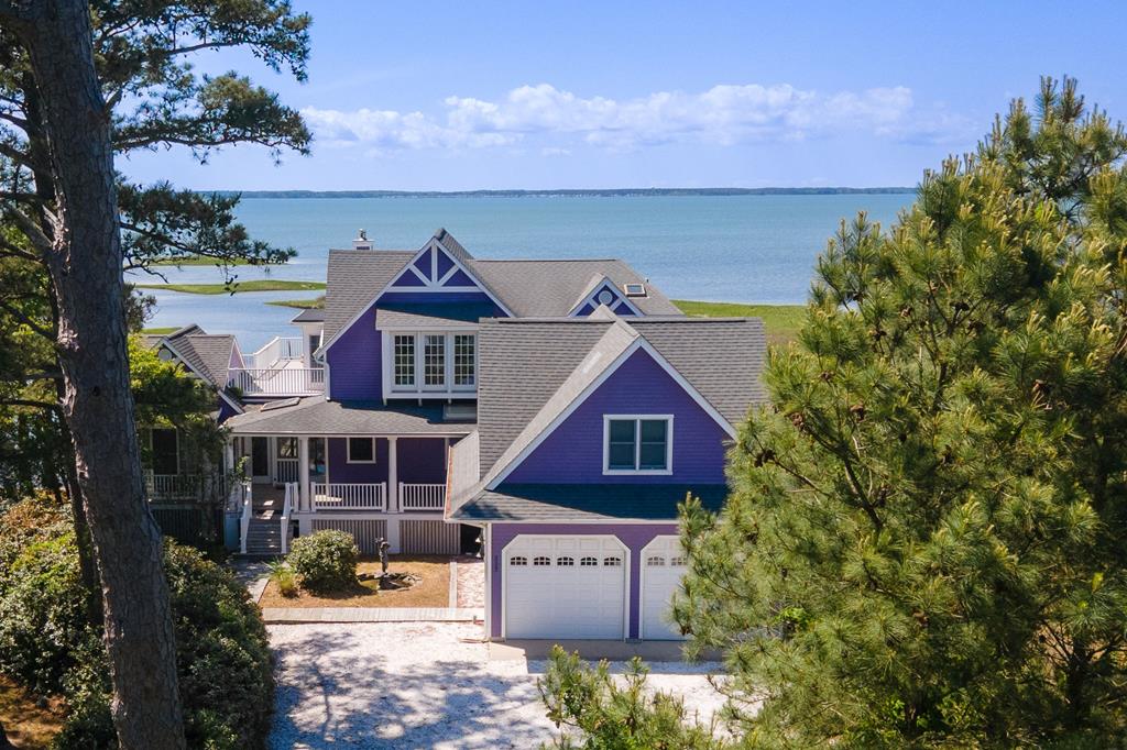 The Ultimate Island Experience. This stunning property, known as Blake's Purple Point sleeps 12,offers expansive water views of Chincoteague Bay & an expansive 3,077 sq ft. of living space.  Designed to accommodate a variety of lifestyles w/ ease & a modern beach house elegance. Featuring well-appointed bedrooms, (including 2 luxurious king rooms, 2 additional bonus rooms), a beautiful & spacious kitchen, living spaces that overlook the glimmering Bay & 3.5 modern bathrooms, this home is an ideal retreat for those who value space, comfort & style. Perfect for culinary enthusiasts, wildlife enthusiasts or those just looking to come to the beach to relax & unwind. The property is exquisitely landscaped w/ a screened porch & decks overlooking the water- making every day feel like a vacation.