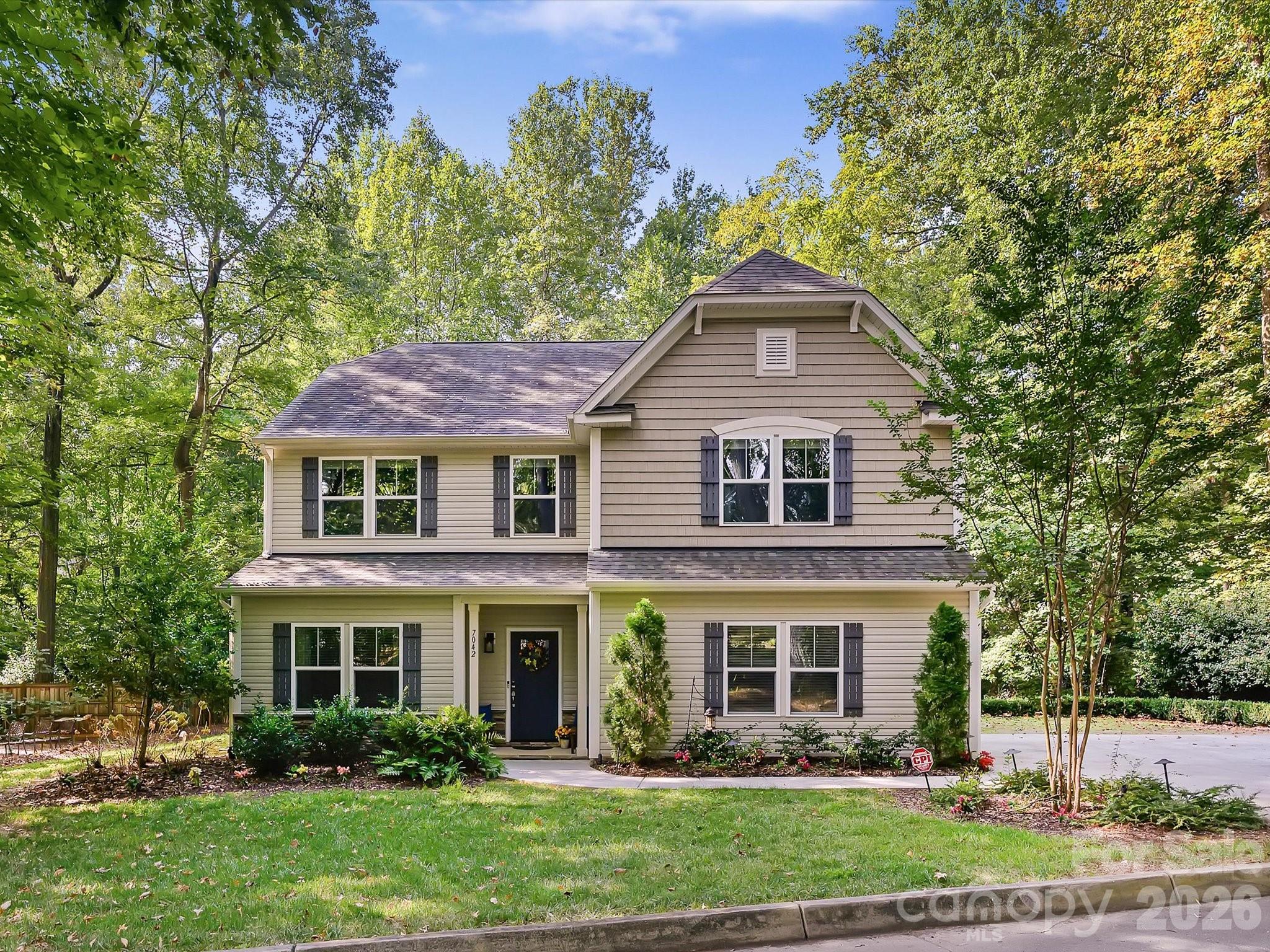 Beautifully maintained newer construction in one of Charlotte's most desirable neighborhoods, tucked away on a private cul-de-sac overlooking a wooded backdrop and creek. Built in 2018, this thoughtfully designed home offers generous living spaces, quality finishes, and an exceptional location convenient to Cotswold, SouthPark, Matthews, Uptown, parks, greenways, and major transportation corridors.The main level features a spacious great room anchored by a stacked-stone gas-log fireplace, a formal dining room, and an expansive kitchen with a large island, marble countertops, tile backsplash, stainless steel appliances, and butler's pantry. The adjoining breakfast area opens to a covered patio and additional outdoor living space overlooking the trees, creating an ideal setting for everyday living and entertaining.Upstairs, the spacious primary suite is complemented by three additional bedrooms and a versatile bonus room ideal for a home office, media room, playroom, fitness space, or second living area. Dual vanities in both the primary and secondary baths, an upper-level laundry room, oversized storage closet, and abundant storage throughout add everyday convenience.A whole-house generator provides year-round peace of mind, while the private wooded setting offers a rare sense of retreat just minutes from some of Charlotte's best shopping, dining, and entertainment destinations.