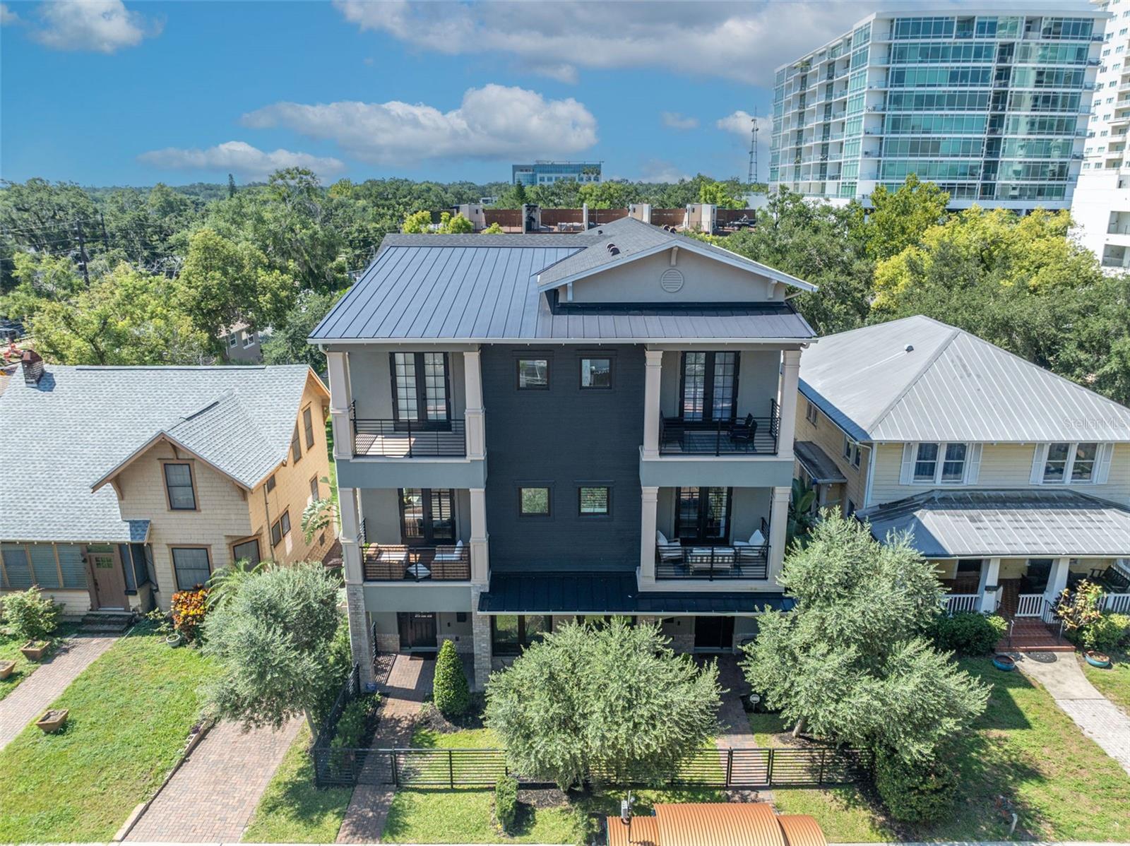 Step into luxury with this stunning townhome, perfectly located near Thornton Park. Designed with elegance and function in mind, this residence showcases top of the line Viking appliances, wine storage, and a gas range, perfect for a home chef and entertaining. Soaring 10-foot ceilings and two private balconies create an airy, inviting atmosphere, while every bedroom features a custom built-in closet system for smart, streamlined storage. A spacious, 2-car garage features tall ceilings, professional-grade overhead storage, and a versatile wall-mounted system to keep everything in its place. Located just minutes away from Thornton Park, the Dr. Phillips Center, Kia Center, Exploria Stadium, and some of Orlando’s finest dining and shopping. With quick access to the airport, major highways, and theme parks, this home offers the perfect mix of luxury city life in a perfect location. Don’t miss the chance to make this elevated retreat your own. Schedule a private showing today.