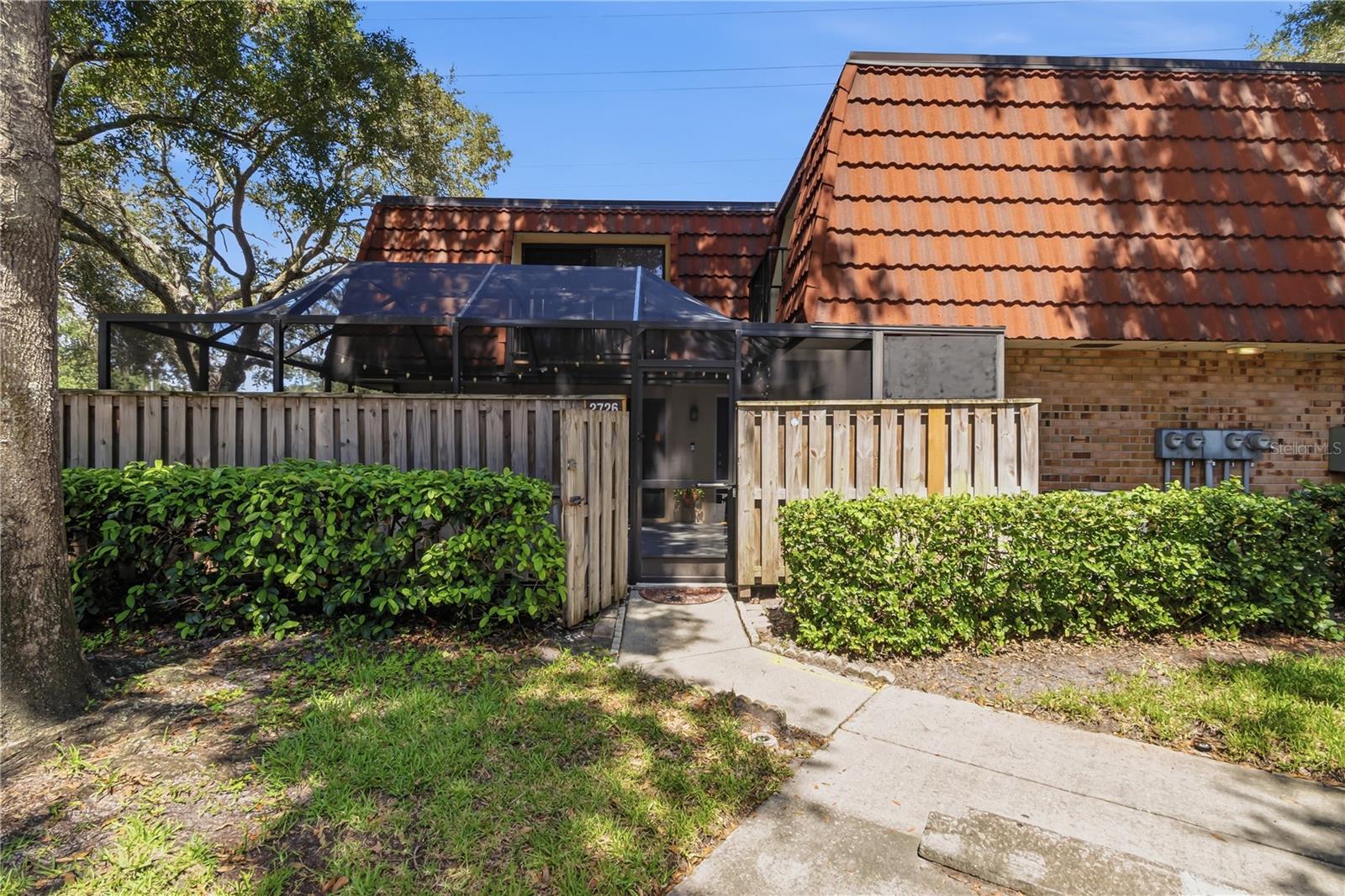 Excellent location!  Beautifully updated and extremely well maintained!  This two bedroom/two and one half bath townhome is in a prime Palm Harbor neighborhood.  Wedgewood of Palm Harbor is a tree lined community that is exceptionally pretty and well managed.  Wind through the streets back to this townhome which has one of the highest elevations in the neighborhood.  Flood zone X- no flood insurance required and no water intrusion during the storms of 2024.  Enter through the large screened patio which is ideal for outdoor entertaining and relaxing.  Plenty of room for your BBQ grill.  The floorplan offers a spacious living room, a fully updated kitchen with gorgeous cabinets, granite countertops including a center island, stainless steel appliances, tiled backsplash and pendant lighting.  Sliding glass doors from the kitchen and living room lead out to the screened patio.  The laundry room is on the first floor and shares space with the half bathroom.  Brand new water heater 2026.  The second floor primary bedroom has a generously sized walk-in closet and a fully updated ensuite bathroom with 12x24 tile, updated cabinets, dual sinks and granite countertops.  The second bedroom features a full wall of closet space - up to the ceiling. and the adjacent hall bathroom is also fully updated.  Each bedroom overlooks the patio.  Wedgewood of Palm Harbor is a delightful community, quiet and nestled in nature with gorgeous, lush landscaping.  Enjoy the many community amenities:  pool, playground, tennis courts and a fishing lake.  Great access to US Hwy 19 and just a short drive to excellent shopping and dining.  The schools are top notch.  This property is in immaculate condition and truly move-in ready.  Fresh and clean and a pleasure to view.  Come see!  Other information:  Roof age 2013, HVAC age 2022, Water heater age 2026, Water Softener age 2025