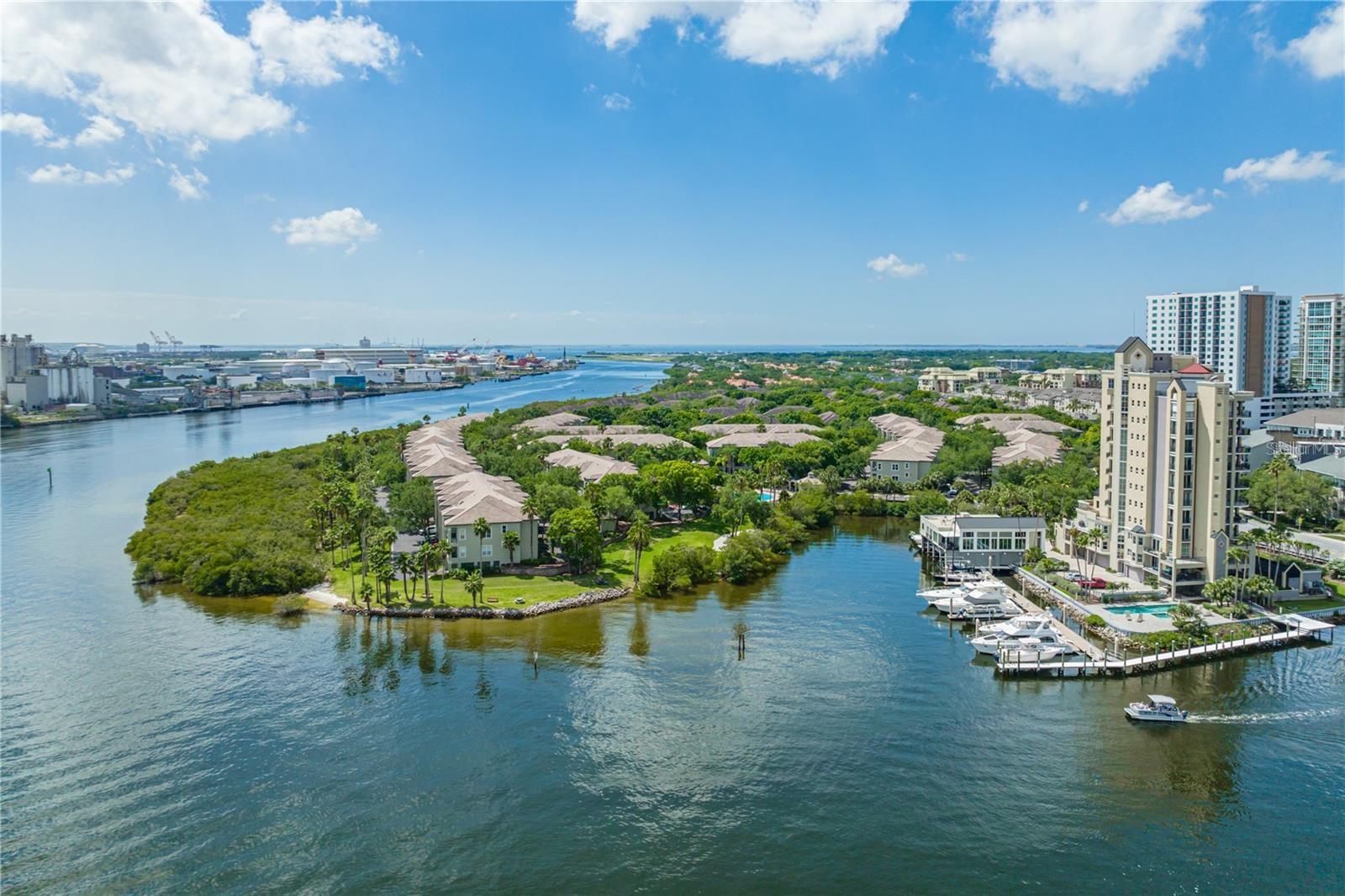 Experience waterfront living in the exclusive, 24-hour guard-gated community of Island Place Residences on Harbour Island. This fully renovated townhome-style condo stands out for its modern, efficient floor plan, 2 bedrooms, 2 baths, and a private 2-car garage, with direct views of Garrison Channel. It's just a short walk to Water Street, Sparkman's Wharf, the Tampa Riverwalk, Downtown Tampa, the Channel District, upscale dining, lively nightlife, and the BIA arena, home to Lightning hockey games and concerts.Step into this beauty of a residence spanning 1225 square feet across three levels, with every detail thoughtfully curated, designer furniture, and exquisite decor throughout. The spacious living layout features high ceilings, natural light, and a private balcony, offering peaceful views of the Garrison Channel, where cruise ships and boats pass by. Elevated finishes include luxury vinyl flooring, hurricane-impact windows and sliding doors, designer lights, cable railings, custom closets, barn doors, modern finished doors, hurricane-rated garage doors, remote roller shades, electric sheer drapes, LED medicine cabinets, and high-end finishes throughout. The open kitchen combines style and functionality, featuring elegant marble countertops and backsplash, extensive custom cabinets, premium stainless-steel appliances, a wine refrigerator, a large single sink, a convection wall oven, an electric cooktop, a sleek range hood, and a reverse osmosis water filtration system. The spacious primary suite features designer double closets, barn doors, and an eye-catching en suite bathroom with a walk-in shower. A flexible guest bedroom has a walk-in closet and a custom storage bed, ideal for guests or a home office. Nearby, a second bathroom with a tub offers a perfect spot to relax. The stackable W/D and tankless water heater are behind two modern bypass doors. Residents enjoy resort-style amenities, including a temperature-controlled pool and heated spa, fitness center, tennis courts, clubhouses, scenic walking paths, kayak access, BBQ areas, valet trash service, and a pet-friendly environment. This exceptional Harbour Island residence offers water views, luxury upgrades, 4 parking spaces, and is located in one of Tampa’s most walkable areas.