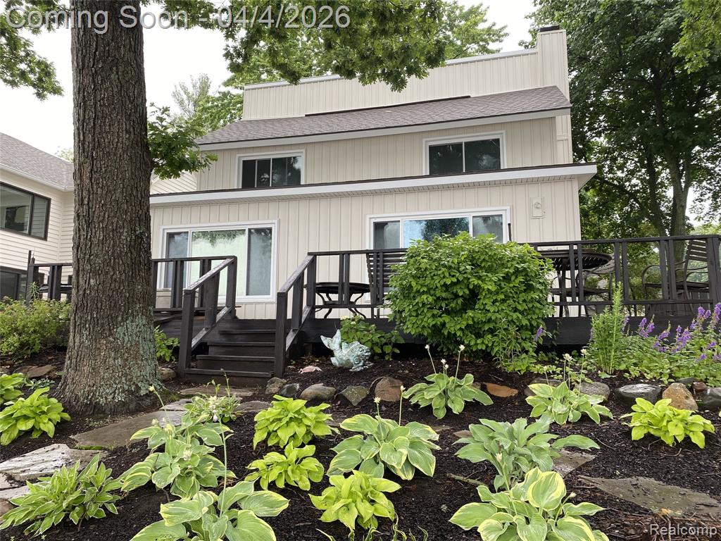 Experience the beauty of lake life with 50 feet of private lake frontage on Zukey Lake, part of the Huron Chain of 9 lakes.  Nestled along paved roads in a peaceful, sought-after setting. This home blends modern luxury with effortless comfort, offering a long list of high-end updates that make everyday living feel extraordinary. Inside, you’ll find a stunning array of updates, beginning with the state-of-the-art kitchen featuring ceiling-height cabinetry, a subway tile backsplash, a generous snack bar, abundant pantry storage, and premium stainless-steel appliances including a Thermador oven/microwave, induction cooktop, Bosch dishwasher, and built-in refrigerator. Luxury vinyl plank flooring spans the main level, complemented by tile in the updated main bathroom. Efficient mini-split systems provide comfortable heating and cooling throughout. The expansive great room stretches across the lakeside of the home, offering a spacious sitting and dining area facing west with magnificent sunset views and a natural fireplace that can easily be converted to gas with the existing line. Both bathrooms have been fully renovated with tiled walk-in showers, modern vanities, and stylish tile flooring. The large primary bedroom enjoys beautiful lake views, and the upstairs office offers flexibility, easily converting to a fifth bedroom if needed. A spacious laundry/mud room adds convenience and additional storage.  Additional storage can also be found in the oversized 2 1/2 car garage which also has an EV charger for electric cars. Step outside to beautifully maintained perennial gardens, an attractive paver walkway, and a wraparound deck that invites you to enjoy morning coffee, evening cocktails, and everything in between.