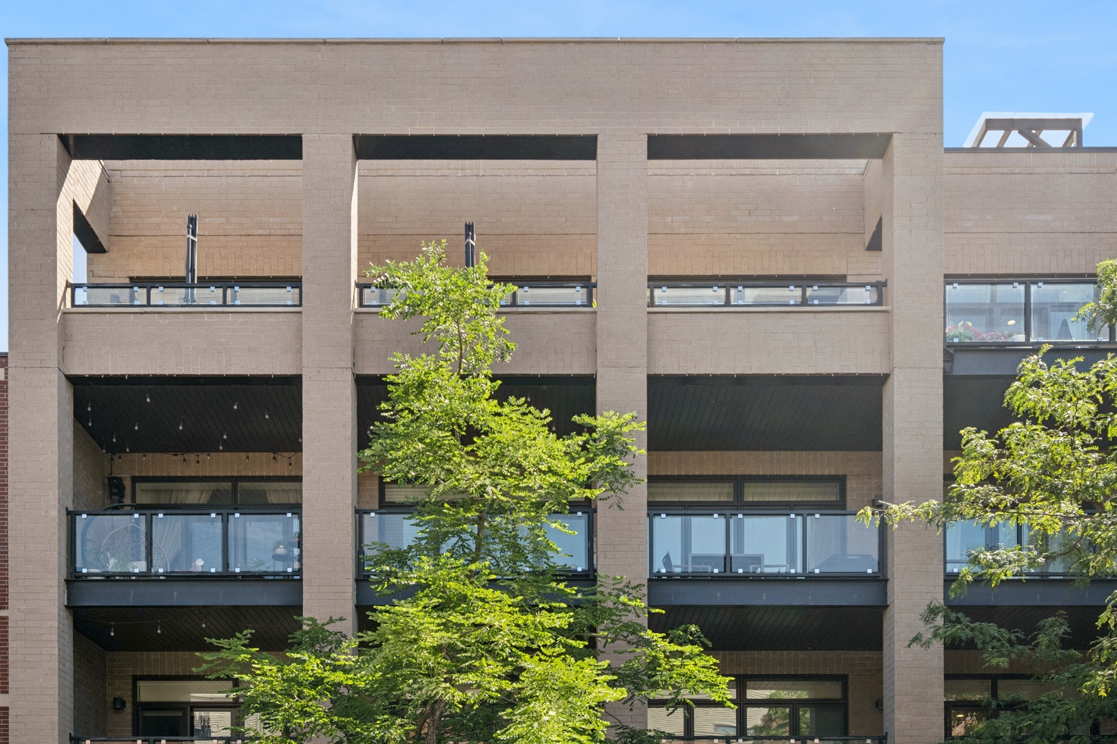 Stunning and spacious penthouse in a boutique elevator building, ideally located in North Center/Lincoln Square. This wide, open floorplan is perfect for entertaining, featuring solid white oak flooring throughout and an expansive living and dining area that flows seamlessly into a custom chef's kitchen with stainless steel appliances, quartz countertops, coffee bar with wine fridge. Step out onto the 23-foot-wide front terrace directly off the living area-perfect for morning coffee or evening cocktails. The luxurious bathrooms feature transitional cabinetry, with a spa-like primary bath offering heated floors and a walk-in rain shower. Additional highlights include oversized side-by-side washer and dryer, in-unit speakers, and abundant natural light throughout.  A standout feature is the interior staircase leading to your private rooftop deck-partially covered for outdoor movie nights-with plenty of space to grill, play, or relax in style. Enjoy the convenience of an oversized 1.5-car private garage and a walk-to-everything location: steps to public transit, top-rated restaurants, beautiful parks, and located within the highly sought-after Coonley School District. This is city living at its best-sophisticated, spacious, and thoughtfully designed for modern lifestyles.