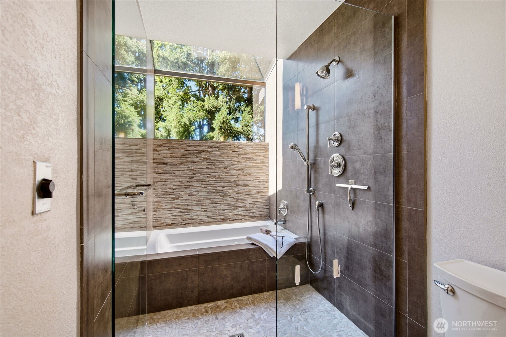 Spa-inspired bath featuring a soaking tub and walk-in shower.