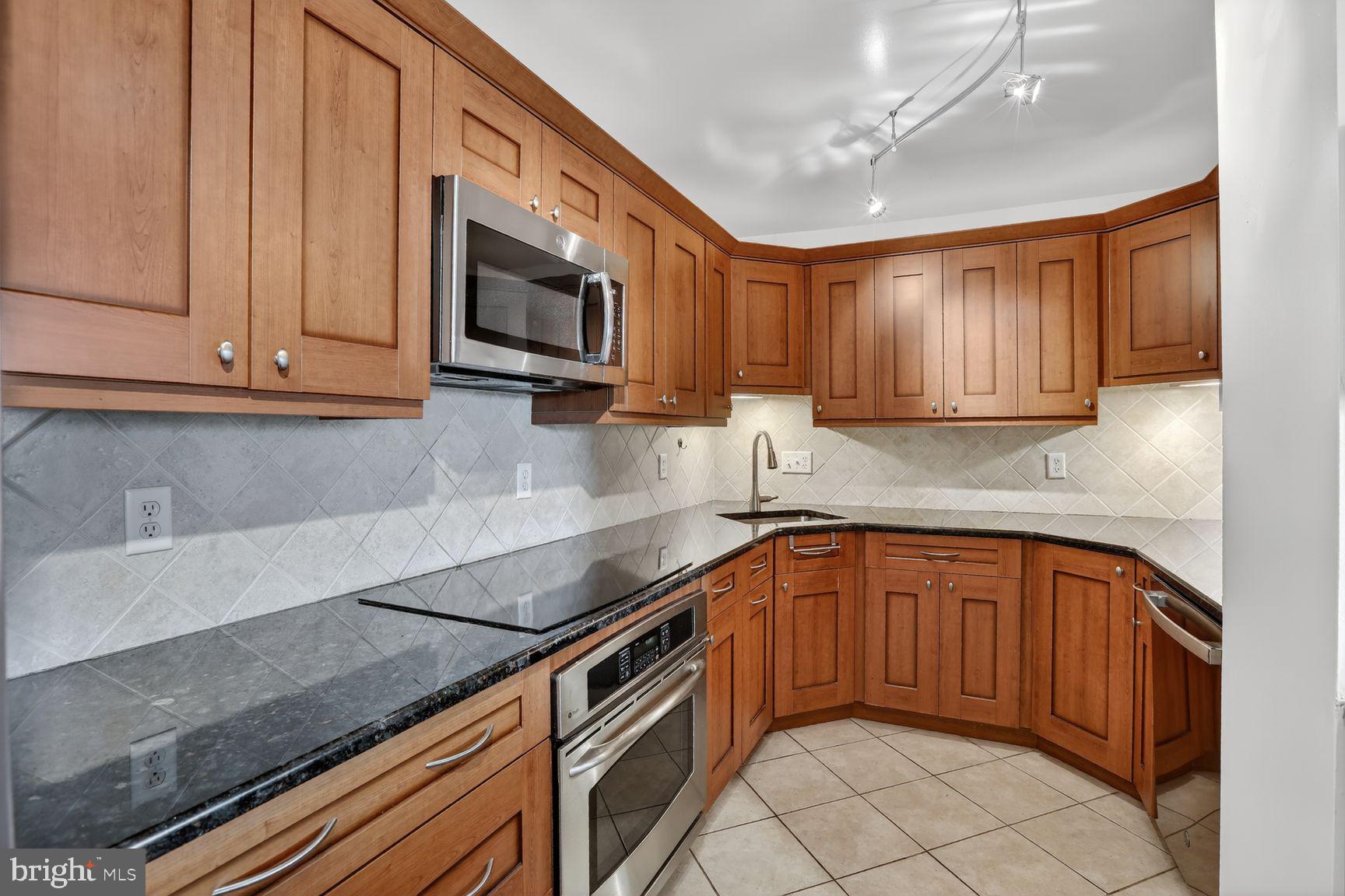 Welcome to 1101 Saint Paul Street #412, a spacious 2-bedroom, 2-bath condominium located on the northern edge of Baltimore's historic Mount Vernon neighborhood. Offering over 1,300 square feet of living space, this unit combines comfort, convenience, and an unbeatable location.  Inside, you'll find hardwood flooring throughout the main living areas.  The open floor plan provides generous living and dining spaces, while the kitchen features granite countertops, stainless steel appliances, a newer dishwasher and newer garbage disposal.  The spacious primary suite features a large walk-in closet with custom built-in organizers and a private bathroom with a jetted tub. The second bedroom also includes a custom closet system and the full hallway bathroom offers a walk-in shower.Additional features include smart thermostat, a washer and dryer hookup within the unit.   A new hot water heater was installed in 2025.This professionally managed building offers outstanding amenities.   Residents also enjoy the convenience of an on-site pizzeria/takeout options and convenience store located within the building. Parking options include on-street parking or the ability to rent a garage space within the building. Guests can even take advantage of valet parking services.The location is exceptional. Walk to Mount Vernon attractions including The Walters Art Museum, Meyerhoff Symphony Hall, Penn Station, local restaurants, coffee shops, and neighborhood favorites. The Belvedere and The Owl Bar are located just half a block away. Major commuter routes, including I-83, are easily accessible for travel throughout Baltimore and beyond.Don't miss your opportunity to own this spacious condo in one of Baltimore's most historic and vibrant neighborhoods. Schedule your tour today!