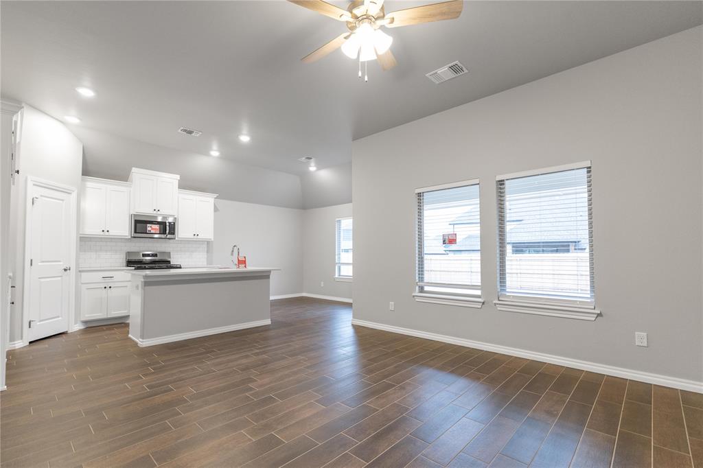 FENCING AND BLINDS INCLUDED! This Tero floor plan includes 1,680 Sq Ft of total living space, which includes 1,565 Sq Ft of indoor living space and 115 Sq Ft of outdoor living space. There's also a 385 Sq Ft, 2-car garage with a storm shelter installed. This affordable home offers 4 bedrooms, 2 full baths, covered patios, and a utility room. The great room welcomes large windows, wood-look tile, a ceiling fan, and Cat6 wiring. The charming kitchen has 3 CM countertops, stainless-steel appliances, wood-look tile, well-crafted cabinets with decorative hardware, a center island, and stylish tile backsplash. The primary suite is straight ahead and supports carpet flooring, a ceiling fan, and the perfect sized windows. The attached primary bath suits a dual sink vanity with an elegant countertop selection, an elongated water-saving toilet, a tub/shower combo, and a walk-in closet! The outdoor living section is covered and has fully sodded yards with smart home irrigation control. Other amenities include a tankless water heater, a fresh air intake system, and MORE!