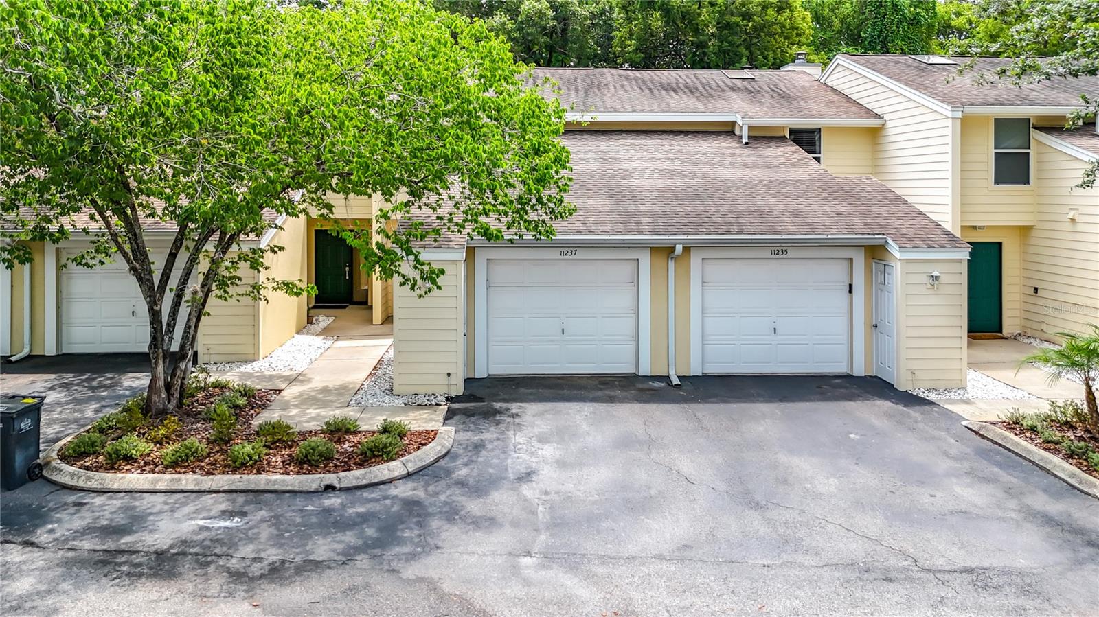 Step into the beautifully remodeled townhome in the heart of Carrollwood lowest priced townhome in Carrollwood with an attached 1 car garage! New floors flow throughout this townhome, as you walk into the living area that features a wood burning fireplace and look out the sliding glass doors into the conservation area in the back yard. The renovated spacious kitchen features Quartz countertops, raised wood panel cabinetry, large sink and stainless steel appliance package. Full size washer and dryer. New AC unit. The loft area at the top of the stairs is perfect place for an office with lots of natural light from the brand new skylight.  Two spacious bedrooms upstairs with the owners retreat that features a balcony overlooking the conservation area.  Bathrooms boast new cabinets with marble countertops, shower/tub combination.  The interior has been freshly painted with neutral tones.  The community is lush and inviting with towering oak trees and a sparkling pool for year round enjoyment.  The low association dues include ROOF REPAIRS AND REPLACEMENT, INSURANCE, water, sewer, exterior maintenance, exterior paint, lawn care.  The townhome is conveniently located in a prime location that places you just minutes from Downtown, Tampa International Airport, major interstates, shopping, dining, and nightlife.  One or more photos are virtually staged with furniture