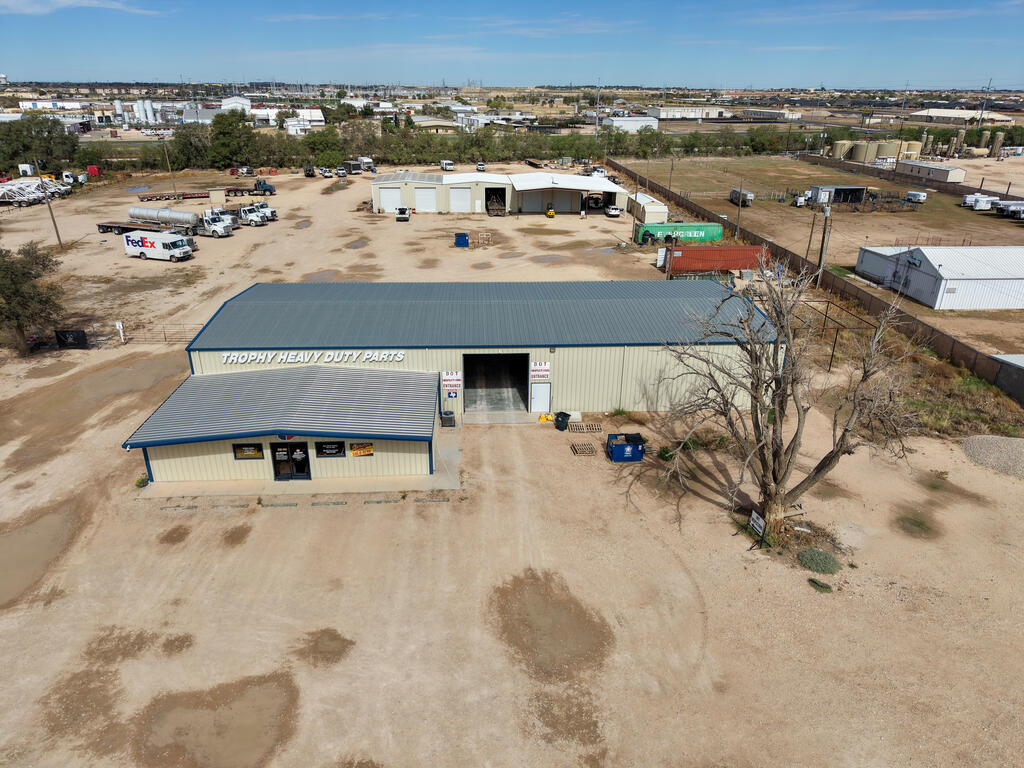 Prime commercial investment opportunity featuring 6.13 acres, two operating businesses, and 12,300 SF of industrial space across two buildings. The 7,500 SF front building offers an open showroom and private office, while the 4,800 SF rear building includes a 1,680 SF canopy. Additional features include a gravel-base yard and metal perimeter fencing along adjacent parcels. Currently generating $7,500 in rental income, this versatile property offers substantial space and income potential for investors or business owners seeking a valuable commercial asset. Option to split property as well.