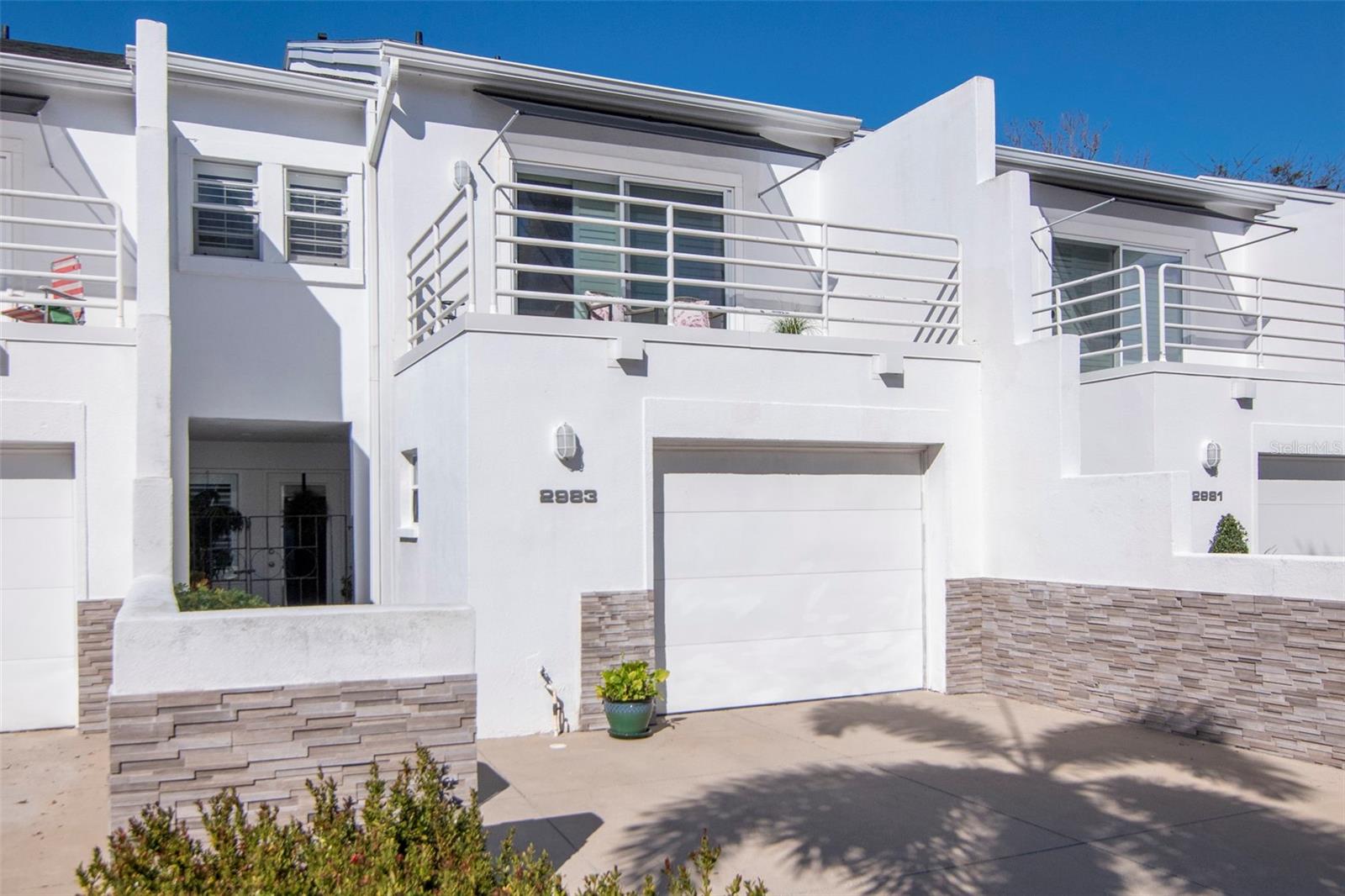 Ideally located in the Courtyards of Tampa, just a few blocks from iconic Bayshore Boulevard, this 2-bedroom, 2.5-bath townhouse blends classic character with distinctive architectural style. Angular walls and rounded metal balcony rails evoke a subtle Art Deco flair reminiscent of South Florida’s timeless design.A private entry courtyard welcomes you home, creating a charming first impression and an inviting space for container gardens, morning coffee, or evening relaxation. Inside, the first floor features a welcoming foyer, a spacious living room with soaring ceilings, a dedicated dining area, kitchen, convenient half bath, and a screened rear patio—perfect for entertaining or unwinding in comfort.Upstairs, you’ll find two generous en-suite bedrooms, each with its own private bathroom for comfort and privacy. A secondary staircase leads to a versatile loft space, ideal for a home office, reading retreat, fitness nook, or creative studio.Parking is effortless with a private one-car garage and driveway space for two additional vehicles, providing convenience for residents and guests alike.Residents enjoy access to the community pool and the peace of mind of a comprehensive HOA that includes professional management, water, sewer, trash, roof reserves, exterior paint, exterior pest control, termite bond/warranty, landscaping, and pool maintenance.Perfectly positioned in South Tampa, this home is just minutes from premier shopping, dining, entertainment, and the vibrant lifestyle that makes Tampa one of Florida’s most desirable places to live.