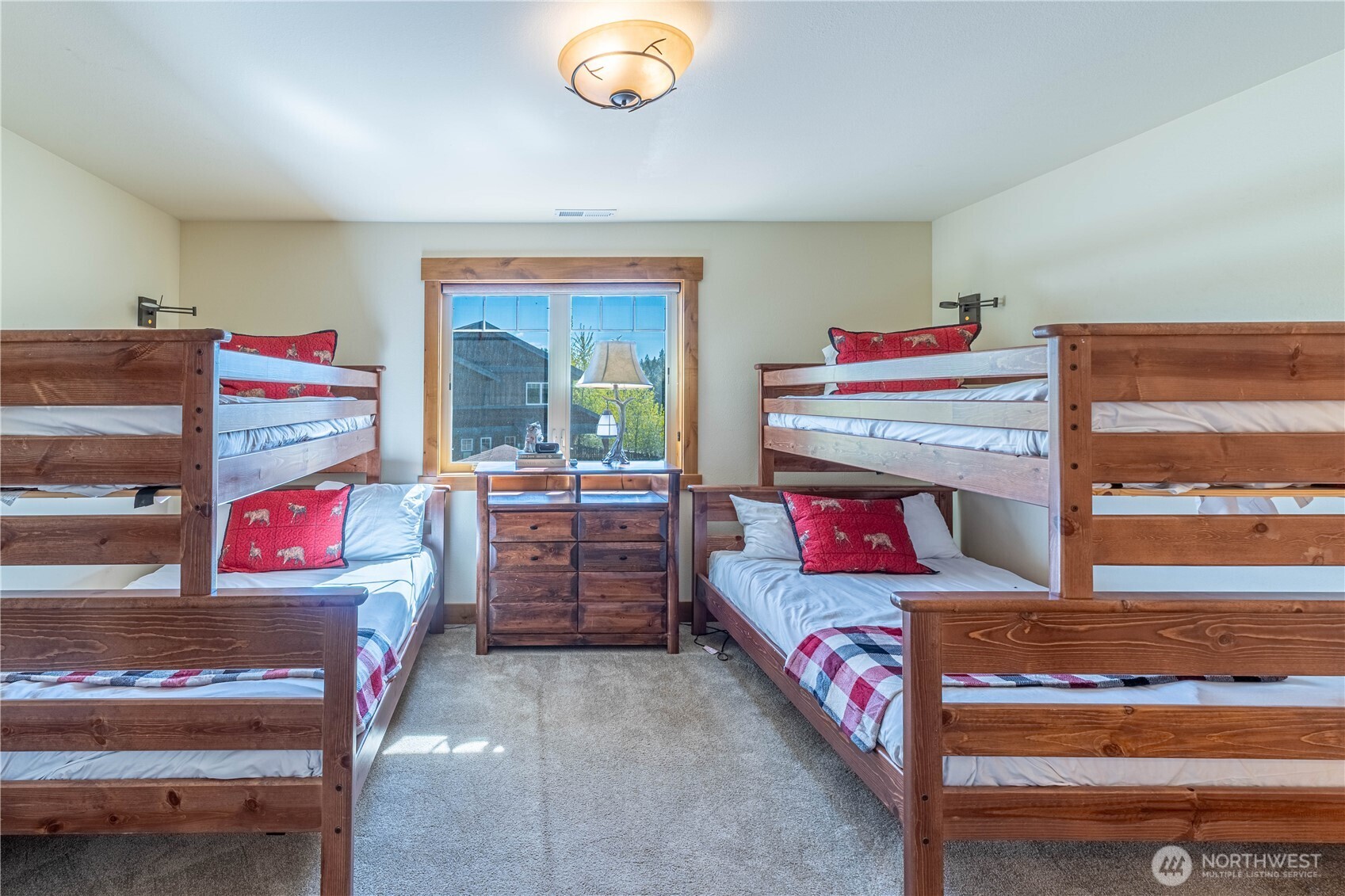 Spacious bunkroom featuring two full beds and two twin beds, perfect for guests of all ages.