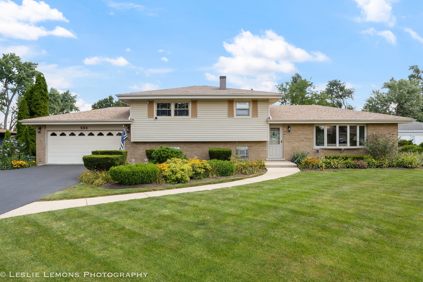 Seller says to price this to sell fast! This extensively updated and well maintained split-level is just what you've been waiting for! Features include an open concept kitchen/living room design with updated cabinets and quartz countertops, an eating area island table with a bay window overlooking the beautifully landscaped back yard, three nice sized bedrooms all with brand new carpeting (hardwood floors underneath), updated hall bath with dual sinks and 5ft shower, lower level family room with newer gas fireplace and full bath, nice size two car attached garage with tons of storage space, Newer Roof & Gutters (2022), Newer AC (2022), New hot water heater, Newer driveway, Hardwood floors nearly everywhere and most of the windows and exterior doors have recently been replaced as well. It also includes a Generac whole house back up generator! A real nice place to call your home! Quick close possible. (please exclude the ring security system and doorbell)