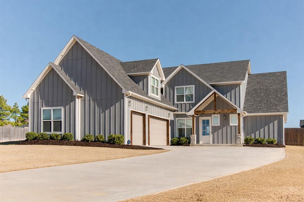 Exceptional modern farmhouse living with elevated finishes throughout. Striking curb appeal begins with a cathedral-style front porch accented by cedar beams. Inside, the entry sets the tone with elegant wood beam detailing throughout. A private office with French doors sits just off the foyer, while the main living space is filled with natural light from a wall of windows and sliding glass doors that open to a spacious covered patio. The living room features a beautiful fireplace with a charming hearth and rich wood-grain tile floors. Designed for both everyday living and entertaining, the open-concept layout flows seamlessly into the kitchen and dining area, showcasing a large center island with ample seating, commercial-grade appliances, floor-to-ceiling cabinetry, and a walk-in pantry. The owner’s retreat is thoughtfully tucked away in its own wing and offers a spa-like en suite with a freestanding tub, walk-in shower, double vanities, and direct access to an oversized walk-in closet with custom built-ins. Upstairs, you’ll find three additional bedrooms, a large bonus room that could serve as a fifth bedroom, and a full bath with double vanities. Additional highlights include a spacious three-car garage and a generous 0.76-acre cul-de-sac lot with room to grow or add a shop. Located in Edmond schools and close to shopping and amenities. Schedule your private showing today—this one is not to be missed.