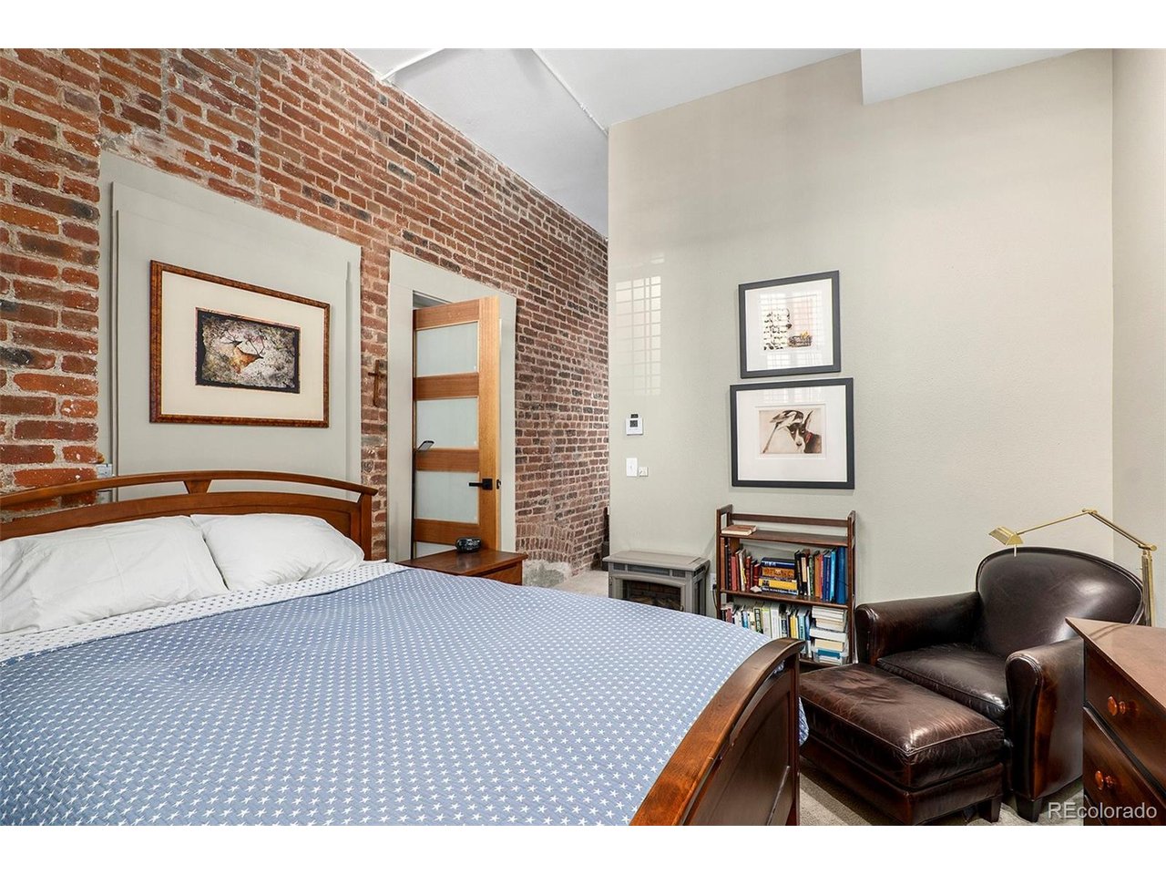 School's out for the summer! Step into a unique piece of Denver history with this charming condo in the iconic Stevens School building, nestled in the heart of Congress Park. Originally built in the early 1900s and converted to condos in the 1990s, the building blends rich architectural character-like soaring ceilings, exposed brick, and oversized windows-with tasteful modern updates. Inside, you'll find an open layout filled with natural light, stylish new ceiling fans, and a newly installed under-sink water filtration system and spigot in the kitchen. The living room features an LED lighting upgrade, offering both efficiency and warmth.The spacious primary suite is a true retreat, complete with a large walk-in closet, IN UNIT LAUNDRY, and an updated en-suite bathroom featuring a beautiful teak wood shower floor. The open-concept living, dining, and kitchen areas create an ideal flow for both relaxing and entertaining. The second bedroom could be used as a home office which can be closed off with its $3,000 pivot door, and lined with custom bookshelves. With a MASSIVE storage closet inside and two parking spaces included, you'll enjoy rare convenience in one of Denver's most walkable neighborhoods-just blocks from Congress Park, Cheesman Park, the Botanic Gardens, and a variety of local cafes, shops, and restaurants. This home offers the perfect blend of historic charm and modern comfort in a truly special setting.