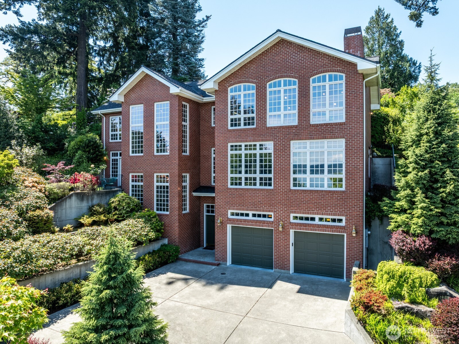 Beautifully designed and built in 2003, this stunning Windermere residence offers dramatic, yet comfortable, living spaces throughout and just the right touches of luxury and elegance. Rare combination of scale & style as rooms flow out to multiple patios & beautifully landscaped grounds. Quiet, secluded and peaceful.  A large kitchen island faces the wall of windows looking at Lake WA and Cascades.  Kitchen features ample counter space, display shelves, and storage; as well as a butler's pantry. Great room concept between the kitchen and family room has cathedral ceilings and gas fireplace.  Exceptional formal dining room with lighted built-in cabinets and French doors leading to the patio. Soaring ceilings, amazing view, gas fireplace and built-in lighted display shelves highlight a comfortable, yet elegant living room. The primary suite has French doors to a private patio, spa-themed 5-piece bath and walk-in closet. Two additional bedrooms are found on the second level along with a dedicated home office with a wall of windows looking at the lake and built in shelving (potential 4th bedroom).  Lower level includes elegant entryway, 2 car garage, multiple storage closets and foyer to 3 story elevator, making the entire home accessible. Extraordinary landscaping.  10 connected, built in speaker system throughout house.  Windermere is THE epitome of Seattle neighborhoods.  Coveted Windermere Park & Beach Club a few blocks away!  Seller related to Listing Agent