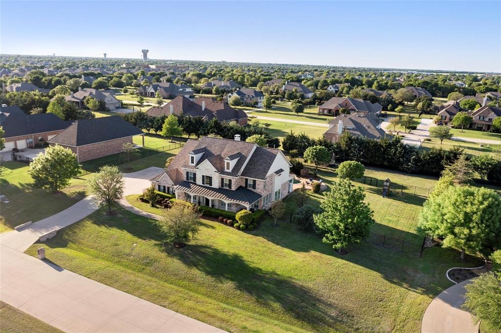 Experience refined luxury in this 4,381-sqft estate nestled within the exclusive Parker?Village community. Set on a picturesque one-acre lot, the home welcomes you with a grand foyer, soaring ceilings and abundant natural light that flows into an expansive open-concept living area ideal for both entertaining and day-to-day comfort. The gourmet kitchen features premium stainless-steel appliances, a generous island and elegant granite countertops. The primary suite is a serene retreat with a spa-inspired bath and an expansive walk-in closet, while a thoughtfully designed secondary primary suite provides additional privacy. Outside, your private oasis awaits with a resort-style pool, spa and covered patio. Just minutes from top-rated schools, upscale shopping at Watters?Creek and exceptional dining, this property blends sophisticated living with the convenience of a prime Parker location.