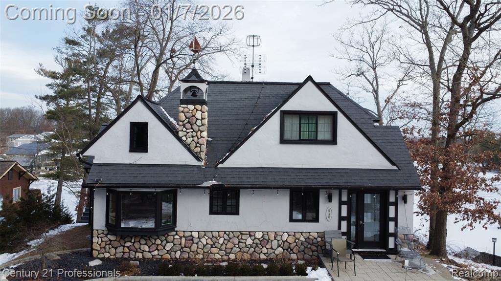 Beautifully sloping property with expansive waterfront views and over 80 feet of frontage on all-sports Lake Orion. The home’s unique design offers versatility and cozy charm, making it ideal for a variety of living arrangements. The main residence features an efficient layout with two bedrooms and two full bathrooms.A separate loft-style living quarters above the spacious three-car garage provides exceptional space for guests, extended family, or older children. This home has been continuously remodeled and showcases a new gourmet chef’s kitchen complete with high-end stainless steel appliances. Major mechanical updates include newer boilers, instant hot water, Andersen windows, and refreshed landscaping.Relax by the fireplace in the living room, unwind in the heated-floor sunroom, or dine in the breakfast nook; each offering stunning lake views and access to the deck overlooking the water. The lower-level primary suite features a private bathroom and direct access to the lake, creating a true waterfront retreat.