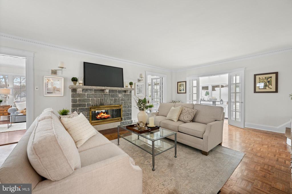 Wow! Come see the upgrades! Freshly painted, wallpaper removed, hardwood floors refinished, kitchen and baths updated. Move in ready! Welcome home to 412 N. Rolling Road in popular Springfield. Spacious and gracious describes this lovely stone colonial, built in 1920 that sits on a very generous .72 acre lot with mature trees and shrubs. This home features  3,379 square feet that invites comfortable living and refined entertaining. Upon entry, be greeted by a spacious living room adorned with hardwood flooring and a gas stone fireplace, leading seamlessly to a cozy family room through elegant French doors. Here, the double sided fireplace and walls of windows create a warm, inviting atmosphere. The adjoining sunroom, with its expansive glass roof, offers a serene retreat to enjoy the changing seasons. The kitchen is equipped with modern conveniences, like a stainless steel JennAir commercial grade 48" gas range, white cabinets and a delightful breakfast room. Additional features include a powder room, a full laundry room, and an attached two-car garage with bonus room above (it was uses as a playroom for years) and a side storage shed. The formal dining room, with its triple windows, crown molding and Baldwin brass chandelier & sconces set the stage for memorable gatherings. The second level includes 3 nice-sized bedrooms with hardwood floors and a hall bathroom with new vanity/mirror/light fixture and a tub/shower combo. The third floor features 2 additional bedrooms, a cedar closet and a hall bathroom. Central air conditioning throughout!This charming, stately home has so much space and a much larger lot then most homes in Springfield (almost 3/4 of an acre.) The yard is fully fenced (which is no longer allowed--perfect for a dog) Conveniently located near shopping, schools, community pool, and local parks. Open Houses Saturday and Sunday.