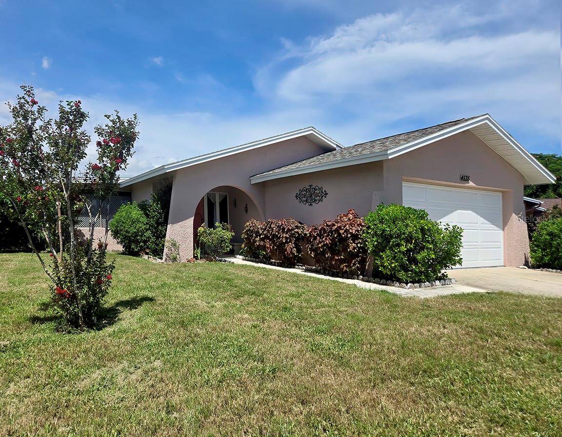Exterior photo: 55+ home with a Florida room and 2023 roof in Clearwater