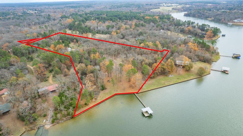 Twelve acres on Lake Bob Sandlin provides a rare opportunity to build and develop a private waterfront retreat! This part-wooded oasis comes with no restrictions, giving you multiple options for use. Enjoy fishing off the pier or from the covered boathouse already on the property. The driveway meanders through mature trees where you’ll also find a workshop with electricity. Just past the workshop, towering pines provide a luxurious setting against the lake. A long gentle slope allows for a multitude of possible building locations with gorgeous views. Additional perks are a well, propane, and retaining wall already built at the water’s edge. Lake Bob Sandlin is one of 3 attached lakes including Lake Monticello, and the skiing and fishing on Lake Cypress Springs. Bob Sandlin State Park sits at the northwest corner of the lake and includes cabins, wooded trails, fishing pier, boat docks, playground, and picnic areas. Lake Bob Sandlin is popular for its fishing where you can find largemouth bass, spotted bass, catfish, crappie, bluegill and redear sunfish. Discover the best balance of water views and 12 acres of wooded privacy. Lots of potential in the popular tri-lake area!
