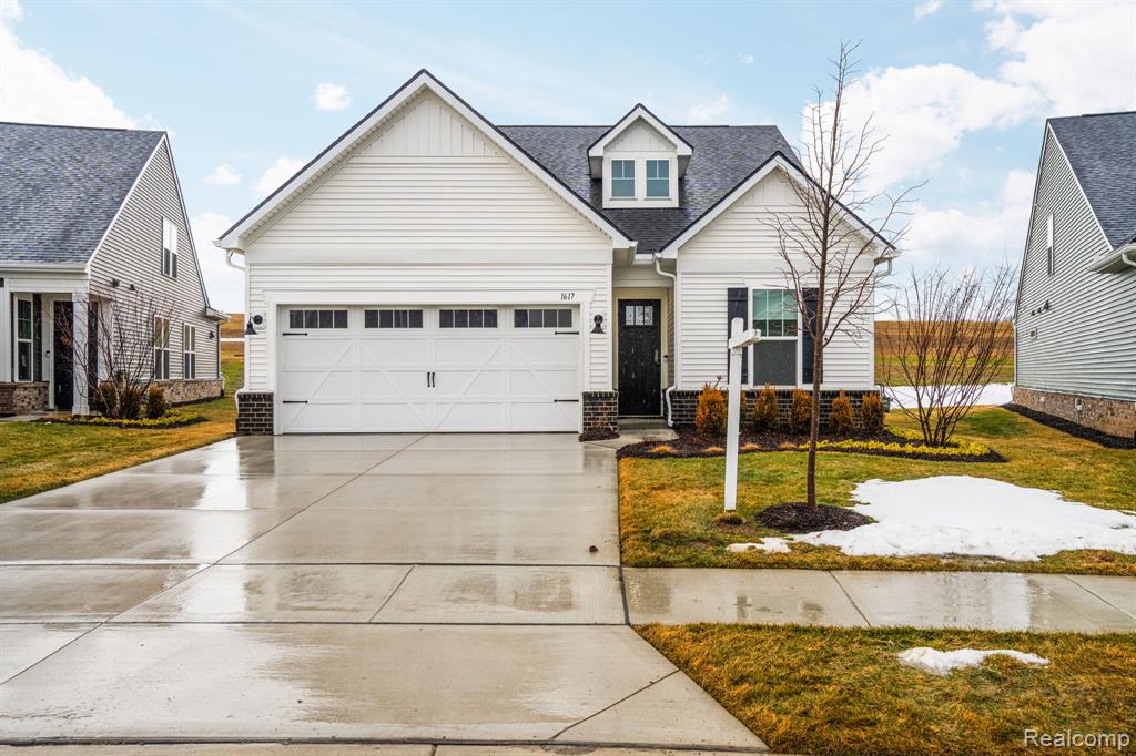 ADDITIONAL EXTERIOR PICTURES COMING SOON. OPEN HOUSES SATURDAY 3:00-5:00 PM WITH TOURS OF THE LAKEHOUSE & SUNDAY 2:00-4:00 PMNo need to wait to build a house in Milford's Kensington Ridge with this almost new Mirage Model that is move in ready. This beautifully upgraded unit offers modern design, comfort, and low-maintenance living. Positioned on a premium lot just steps from the impressive 17,000+ sq ft Lakehouse, this Cottage series home delivers style and functionality in a vibrant, amenity-rich neighborhood.Inside, the open-concept layout features a spacious gathering room with a coffered ceiling, upgraded LED lighting, extensive luxury vinyl plank flooring, upgraded interior doors, and enhanced trim around doors, windows, and baseboards. The chef’s kitchen showcases quartz countertops, gas cooktop, expansive island, walk-in pantry, under-cabinet lighting, soft-close cabinetry, and added designer lighting above the dining area. A bright sunroom expands the living space, while ceiling fans throughout the home enhance comfort.Bathrooms were thoughtfully upgraded with under-mount sinks, tiled floors, and tiled bath and shower surrounds, along with an added glass shower enclosure in the front bathroom. The main-level primary suite offers a spa-like feel with luxury vinyl plank flooring and European glass shower doors. An upgraded electrical panel provides flexibility for a future EV charger.Exterior enhancements include an upgraded front entry door, garage door with windows, oversized two-car garage, extra-wide driveway, and an extended patio overlooking a large commons area — a rare feature within the community.Kensington Ridge is known for beautiful homes and a strong sense of community. Residents enjoy the state-of-the-art Lakehouse with indoor pool and hot tub, fitness center, golf simulator, pickleball, tennis and bocce courts, plus miles of walking trails backing to Kensington Metropark — all just minutes from downtown Milford.