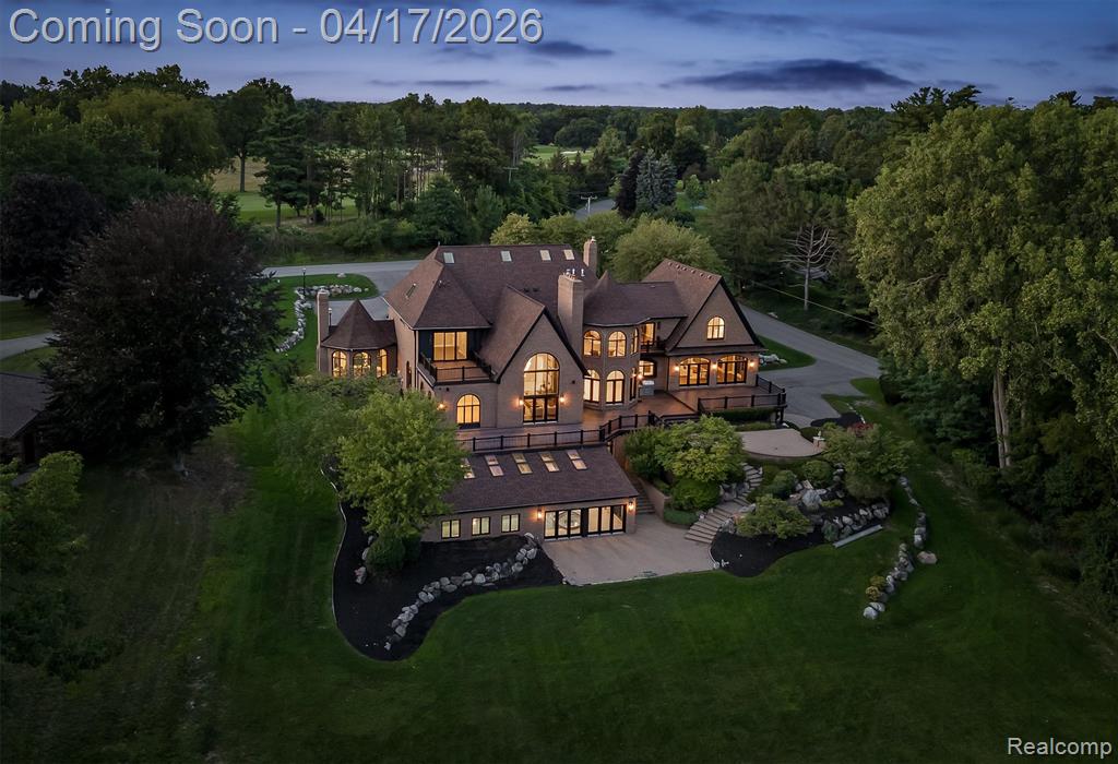 All Sports Upper Straits Lakefront situated directly in front of the Orchard Lake Country Club, this exceptional estate spans over two acres and delivers a rare blend of newer construction, timeless architecture, and true resort-style living. A grand foyer with a sweeping Cinderella staircase introduces interiors defined by scale and elegance, featuring formal living and dining rooms, a fireside family room, and multiple gathering spaces designed for both entertaining and everyday comfort. The chef’s kitchen is thoughtfully designed with dual built-in refrigerators, custom cabinetry, premium stone surfaces, an oversized island, and a Miele coffee station, all opening seamlessly to a breakfast area and expansive deck with panoramic lake views. The second-floor primary suite offers a private retreat with breathtaking water views, a sitting room with fireplace and wet bar, spa-like bath, and its own private laundry. Additional bedrooms across the second and third levels provide flexible living arrangements, including a desirable first-floor ensuite. The walkout lower level is built for year-round enjoyment, featuring a fireside great room, game area, full spa with sauna and showers, and an impressive indoor pool with jacuzzi. Outdoors, manicured grounds, a brick paver terrace, maintenance-free decking, and private dock access complete the lakefront experience. Additional highlights include two elevators, central vacuum, surround sound, full smart home integration, and brand new appliances throughout. The home has not been occupied since completion, offering a truly move-in-ready, like-new experience. A rare opportunity to own a lakefront estate in one of Oakland County’s most prestigious locations. B.A.T.V.A.I. Disclaimer: Original structure built in 1991.