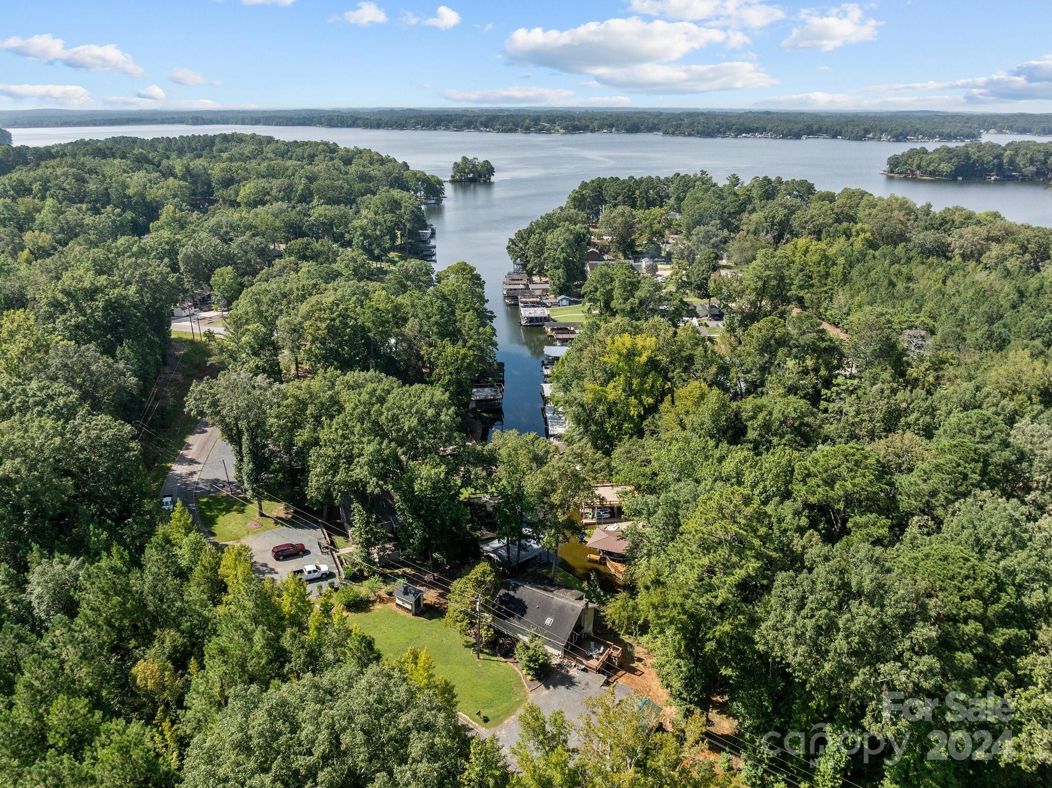 With one downward push of the boat lift switch, 5000 acres of beautiful Lake Tillery are waiting for you to enjoy when you're not relaxing in this charming 2 bedroom 2 bath waterfront home.  A covered lake side porch and open side deck provide lots of space for enjoying the outside.  The vaulted great room helps to make this smaller floor plan feel spacious.  The open living space is convenient for entertaining family and friends.  There is a fenced in area for pets and several outside storage buildings.  The boathouse has 2 slips, 1 that can accomodate a pontoon.  Fairway Shores is a non gated community that has an optional HOA.  Be sure to schedule an appointment to see this home!