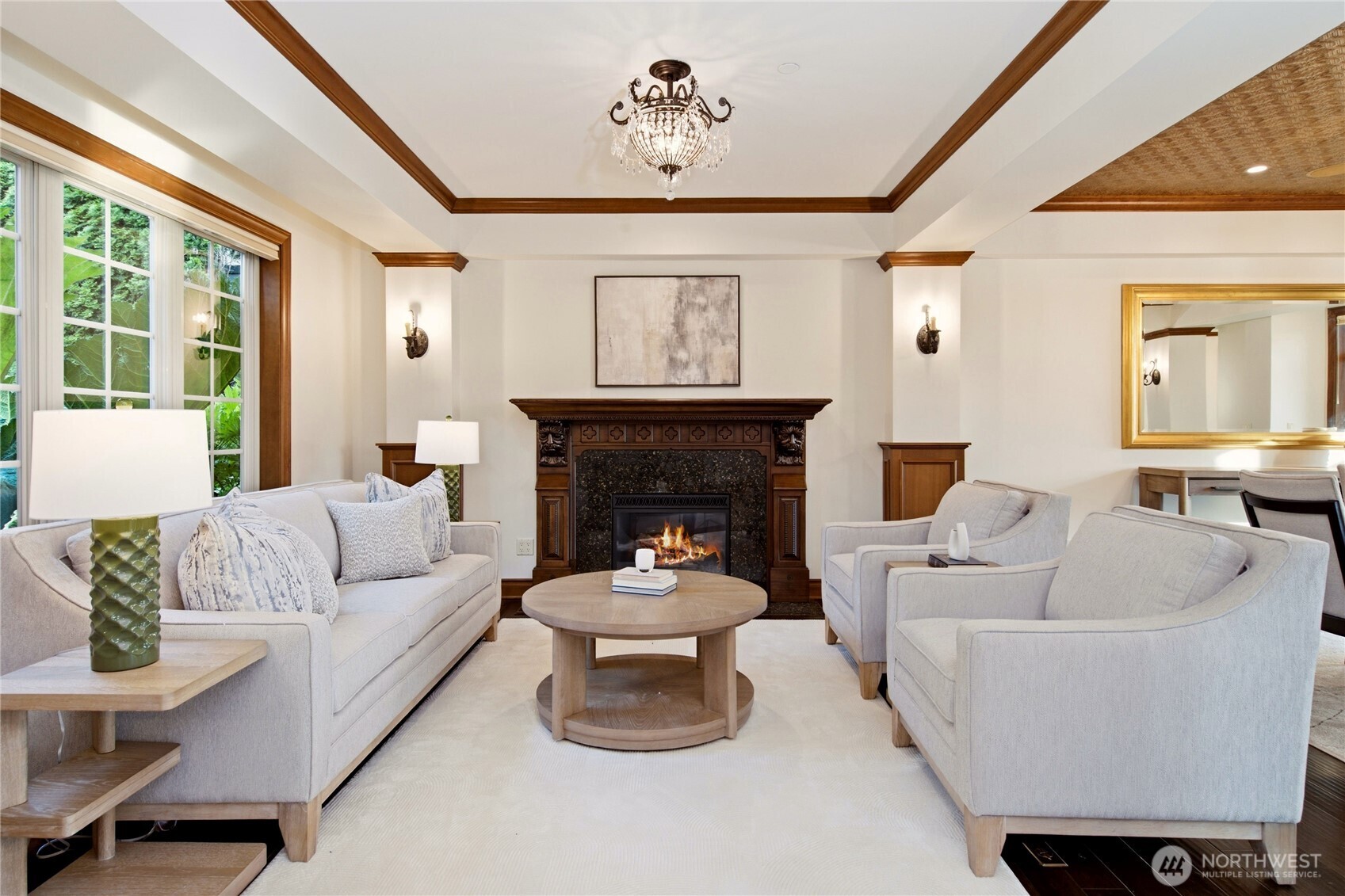 Warm and inviting family room opening to covered outdoor living with panoramic lake views.