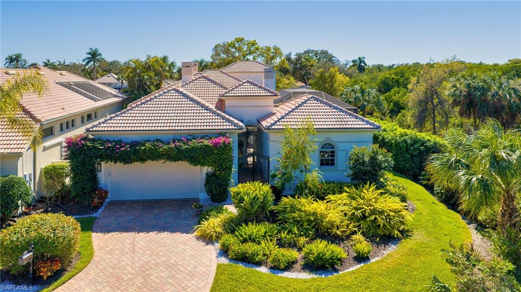 This truly remarkable residence is a masterclass in space, privacy, and resort-style living—designed for those who want room to spread out and places to come together—tucked away at the end of a quiet cul-de-sac in Anchorage at Bonita Bay. The setting is secluded by design, featuring a private roundabout entry, no neighboring home on one side, tranquil preserve views, and a serene lake stretching out beyond the rear of the property. Inside, the home unfolds into multiple living areas across a thoughtfully designed two-story addition, offering exceptional flexibility for everyday living, entertaining, and hosting guests, with Brazilian Teak floors throughout the main living areas, crown molding in the living/dining area as well as the primary suite and den, and Hunter Douglas Silhouette blinds on many of the floor-to-ceiling windows. A detached 1-bed, 1-bath cabana just off the courtyard—with a morning kitchenette and cozy sitting area—offers ideal guest accommodations or a secluded private escape. Inside, the thoughtfully designed layout features two additional bedrooms, a den, and a loft-style bonus space, ensuring everyone enjoys their own place to retreat. Three fireplaces anchor the home with warmth and architectural presence, creating inviting spaces to relax and gather. The kitchen blends timeless craftsmanship with modern convenience, featuring cherry cabinetry, quartz countertops, a generous stainless-steel sink with Moen fixture, bar seating, and a sunlit breakfast area. A bar with wine cooler elevates the entertaining experience. Outdoors, the resort-style lanai feels like a private tropical retreat, complete with waterfall features, covered lounging areas, and app-controlled pool and spa lighting via the AquaLink system. Morning sunrises over the lake set the tone for the day, while preserve views to the rear and side ensure long-term privacy and a serene backdrop. The primary suite features two separate, designated bathrooms with granite countertops—offering a rare and luxurious level of comfort. Additional highlights include a 2019 roof, A/C 2022 and 2026, manual and electric hurricane shutters, and desirable southern and eastern rear exposure. Residents of Bonita Bay enjoy an exceptional lifestyle with championship golf, a private beach park, marina access, scenic trails, tennis and pickleball, a state-of-the-art fitness center, and a rich calendar of social and dining experiences. Ideally located near Riverwalk Park, this residence combines natural beauty, thoughtful design, and the coveted Bonita Bay lifestyle. This private estate was designed for living beautifully, inside and out.