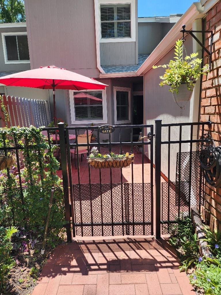 You enter 632-104 Red Oak Circle, through a private gated patio with plenty of room for outdoor entertaining.  This 2-story townhouse in Oak Harbour, a gated community in Altamonte Springs, Fl., which is located on Lake Orienta. This home has 1779 square feet with 3 bedrooms, 2 1/2 bathrooms.  The master suite is located on the main floor and the other two bedrooms and a loft upstairs which overlooks the open living area. Upstairs there is a full bathroom.  The kitchen has been updated with modern appliances and quartz countertops, and the bathrooms redesigned with lots of cabinet space. Two new skylights add to the bright and airy feel of the house, while keeping out the heat.  The windows have new plantation shutters throughout.  There is a spacious one-car garage with a washer and dryer and room for additional appliances.  The glassed-in back porch overlooks lush landscaping and a small, elevated patio.  A new roof was installed and the unit painted in 2022.  Dogs are welcome with no restriction on size or breed. The monthly association’s dues of $613.00 include internet and cable tv.

The dock on Lake Orienta offers the opportunity for fishing and watching the beautiful sunsets.  Bring your boat and park it here.  Families gather at the lake July 3rd for perfect viewing of Red, Hot, and Boom  at Crane's Roost. The recently updated clubhouse at Oak Harbour has a full kitchen, room for the social activities and seasonal events that occur throughout the year.  There is a TV, pool table, ping pong table, and library available. There is also a fitness center.  Other amenities at Oak Harbour include two pools, a tennis/ pickle ball, basketball, and shuffleboard courts.

Schedule a private showing of this townhome and call this spacious, serene home your own.
Oak Harbour is 2 miles from I-4 with lots of shopping, restaurants and churches nearby.  Also, there are two Sun Rail stations close by offering an easy commute to Winter Park and downtown Orlando.
.