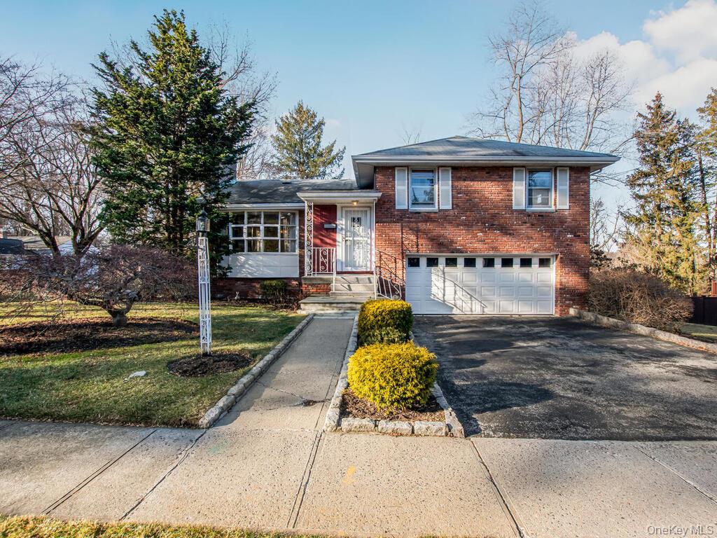 SUNDAY OPEN HOUSE IS CANCELLED>  Welcome to the charming, tree-lined neighborhood, Poet’s Corner, where the streets offer tribute to celebrated poets of the past. This bright and spacious mid-century split-level home sits on a desirable corner lot, offering an abundance of natural light, hardwood floors, central air, and generous living spaces throughout.The main level features an inviting, oversized living room complete with a bow window and a cozy wood-burning fireplace. The seamless flow leads into the formal dining room and eat-in kitchen, ideal for entertaining. The kitchen is equipped with a gas range, good cabinet storage,  preparation space, and convenient access to the rear yard.Upstairs, the bedroom level offers a serene primary suite with a private full bath, along with two additional bedrooms and a full hall bath. The walk-out lower level provides a spacious family room with full bath and glass sliders that open to a covered patio, creating a perfect setting for relaxation or gatherings..Expansive basement level (additional 300 square feet) includes open area, laundry area, utility room, and plenty of storage space. Attached two-car garage.Perfect location close to highways, transportation, local shops, restaurants. Westchester Greenhouse and Farms, Ridge Road Park, Harts Brook Park.  Hartsdale Metro North train station is only a 5-minute drive