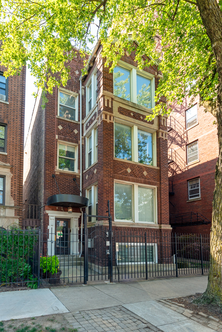 Nestled on the leafy Uptown block of Agatite Avenue is this large and updated 3BR/2BA top floor condo. Streaming with natural light from every direction--from the large windows in the front, to the southern exposure in the back, this home is ideal for those who appreciate open, light-filled living! Stepping into a world of charm and warmth, this home welcomes you in with its gleaming hardwood floors throughout, spacious living room with a gas fireplace, oversized picture windows, and a perfect reading nook looking out onto the street and treetops. The kitchen was thoughtfully reconfigured, opening up the floor plan to create space for entertaining, and is equipped with stainless steel appliances, quartz countertops, and tile backsplash. The space flows perfectly into the adjacent room currently used as a formal dining room, but could also be used as a second living space--rarely found in these vintage apartments! The primary suite offers comfort and privacy, with a custom built-out closet, and a recently remodeled en suite bathroom with dual vanity. Complementing the primary suite are the other two bedrooms, each with ample closet space, and a recently renovated second full bathroom. Additional features include in-unit laundry, ample storage with a large custom pantry, and one garage parking space. Common patio space shared with the three other unit owners in the building, perfect for grilling or enjoying a nice day with a beverage of choice. This location cannot be beat, with every convenience right outside the door! For daily retail and shopping, Jewel, Aldi and Target are one block away. Plenty of coffee shops to choose from like Happy Monday, Loving Heart Cafe, Klein's Bakery, and Stan's Donuts. Great restaurant options like Lucy's, Bar on Buena, and Reservoir. Public transit is easy with Montrose, Sheridan, and Broadway CTA buses within 1-2 blocks, plus the CTA Wilson Red and Purple Line Station 2 blocks away. Enjoy the accessibility of lake life via Montrose avenue with Lake Shore Drive on and off ramps (drive to Michigan Avenue in 12 minutes), lakefront path, Montrose Harbor & Bird Sanctuary, and Montrose Avenue Dog Beach! ***Sellers are offering a one year ACHOSA Home Warranty (Prime Plan with Conserve Plus Coverage, ask for details)!***