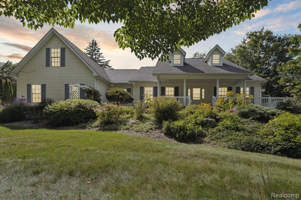 Fabulous Clarkston home has so much to offer! Step inside and you will find beautiful hardwood floors, open floor plan from kitchen to living room with a cozy wood burning stone fireplace.  Entertain in the formal dining room or step outside to the beautiful perennial gardens surrounding the wrap around porch made of composite decking.  Oversized primary bedroom with large bath features a 10x10 walk in closet.  The two other entry level bedrooms have a full-size bath, as well the upper-level loft bedroom.  The lower level is fully finished with a walkout as well two large rooms, which could be used as additional bedrooms or office.  There is also an additional full bath that would make a great set up for an in-law suite.  Some extras include first floor laundry, 3 car attached garage for storage and a large 16x10 shed for all your gardening tools.  Home has been freshly painted with neutral colors throughout and has newer plush carpet. This home is located very close to downtown Clarkston, Clarkston High School, and the I75 for easy commutes.