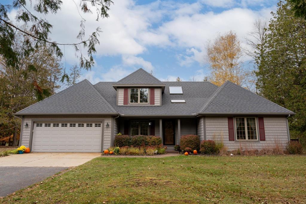 A rare find of nature and neighborhood! 20 acres of tranquility with over 500 feet of Chippewa River frontage AND it's on a private road. Start and end your day in the summer listening to the river from your private screened in porch off the primary bedroom of which also offers a private bathroom and walk in closet. When the summer months of entertaining from your wrap around deck are over, gather with loved ones inside where you have a panoramic view of the river and warmth of the fireplace. Spacious eat-in kitchen offers high end appliances, island cooktop, and Corian counters. Main floor also offers a formal dining room, a second full bath and a second bedroom. Upper-level features 2 spacious bedrooms, guest bath with soaking tub and attic space for storage. A whole house generator gives peace of mind. Additional building with knotty pine interior walls features a workshop, storage, and has a full loft for flex space. This property is truly one of a kind and offers so much opportunity!