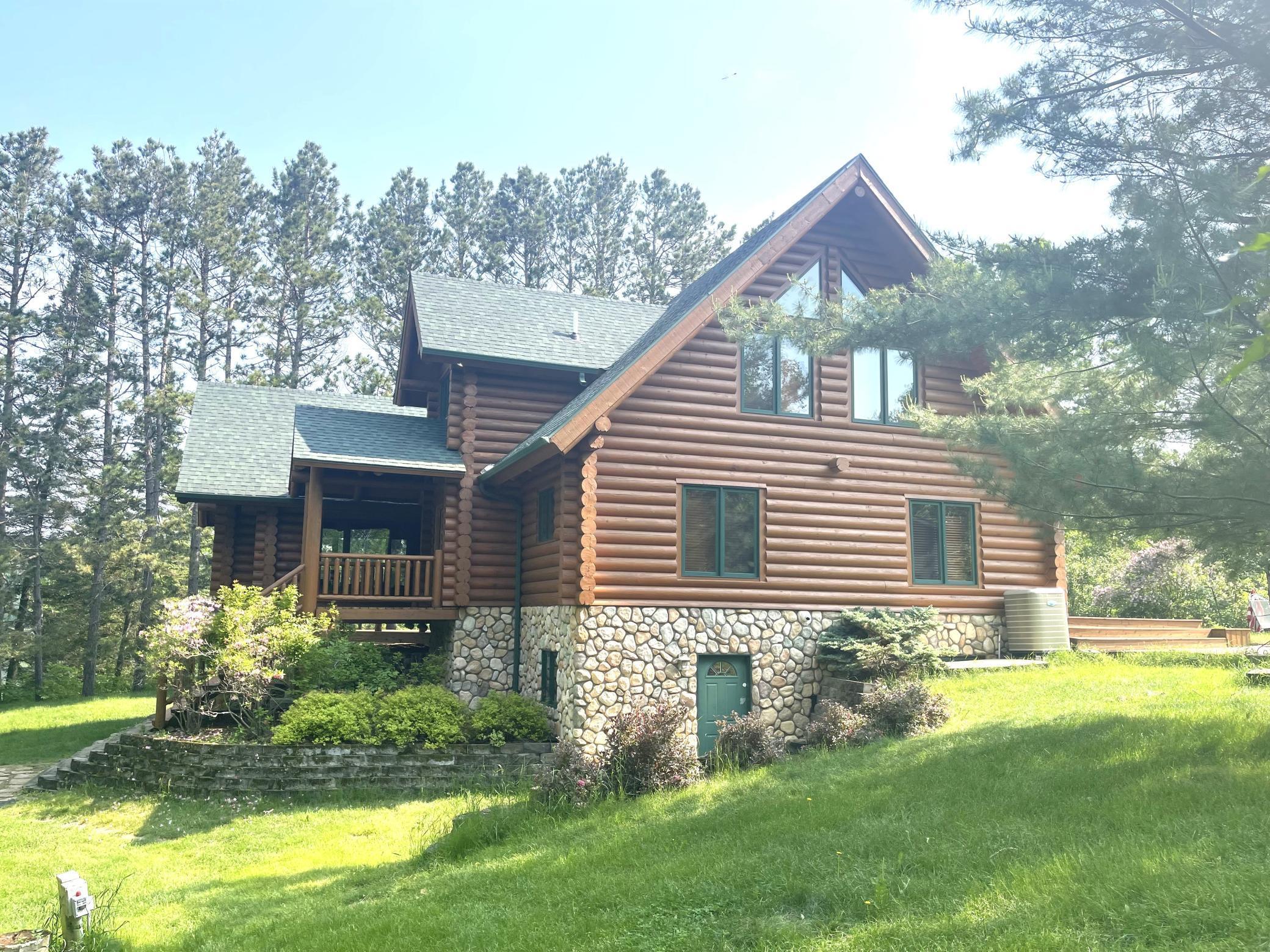 Discover your dream retreat on Island Lake. If you’ve been searching for the perfect blend of nature and comfort, look no further than this stunning log home nestled among towering pine trees and the serene shores of Island Lake. Step inside to find a custom kitchen that will delight any culinary enthusiast. Featuring elegant cherry wood cabinets, a Viking countertop gas stove, a microwave/oven combo, and a convenient garbage disposal, this kitchen is as functional as it is beautiful. The lakeside dining and living room combination boasts a full view of the expansive deck, where you can entertain or simply relax while taking in the stunning scenery. With maple hardwood flooring and a cozy gas fireplace, this space provides warmth and comfort year-round. On the main floor, you’ll find two inviting bedrooms and a conveniently located 3/4 bath. Venture to the upper level, where a spacious loft awaits, ready to be transformed into your personal sanctuary, office, or hobby space. The large primary bedroom also resides on this level, complete with a private full bath featuring a luxurious jet tub and a separate shower for your relaxation. The lower level is a blank canvas, brimming with potential. With a walk-out family room, plumbing for an additional bathroom, and a partially finished bedroom, this space is ready for your creative touch. Set on a peaceful “end of the road” location, this property boasts 150 feet of sand lakeshore, wrap-around decks, and a covered patio on the lower level. The beautifully landscaped perennial gardens and tiered landscaping enhance the natural beauty of your surroundings. Island Lake is renowned for its exceptional fishing year-round, and you’ll find yourself perfectly situated between Itasca State Park and Park Rapids, with easy access to recreational trails and golf courses. Don’t miss your chance to own this slice of paradise. Call today to schedule your appointment and start your journey to lakeside living!
