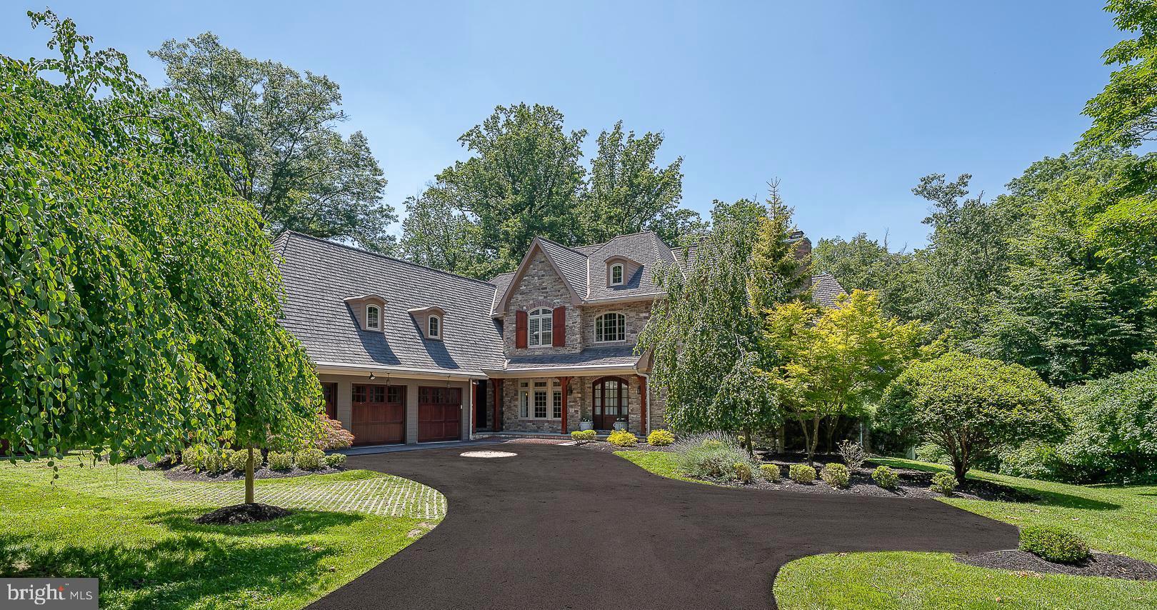 Welcome to 226 McClenaghan Mill Road in Prestigious Wynnewood – A Private 1.18-Acre Estate with Pool and Luxurious Amenities.  This stunning 7,556-square-foot custom residence, located in the award-winning Lower Merion School District, offers an exceptional blend of classic charm and modern luxury. Nestled on a beautifully landscaped 1.18-acre lot with a gorgeous inground pool, this 5-bedroom, 5 full and 2 half-bathroom home is a true retreat.  A grand two-story foyer greets you, flanked by a sun-drenched parlor with a gas fireplace and vaulted ceilings, and a formal dining room featuring exposed beams and elegant wainscoting. The butler’s pantry with a wine fridge connects to a chef’s dream kitchen—complete with dual islands, top-of-the-line appliances, a walk-in pantry, and a sunny breakfast area.  The kitchen flows seamlessly into the expansive great room, featuring soaring vaulted ceilings with exposed beams, a floor-to-ceiling stone gas fireplace, and custom-built-ins. French doors open to a covered balcony that overlooks the pool and serene backyard.  The first-floor primary suite is a true sanctuary, boasting a vaulted ceiling, sitting area, outfitted walk-in closet, and a luxurious ensuite bath with dual vanities, jetted tub, and oversized, walk-in shower. This level also offers two half bathrooms, a laundry room, a small office, and access to garage.  Upstairs, three spacious bedroom suites each feature private ensuite bathrooms and outfitted, walk-in closets. Two include separate office or homework nooks—ideal for today’s lifestyle.  The fully finished walk-out lower level is an entertainer’s dream: recreation room with French doors to the patio and pool, a gorgeous full wood bar, home gym, office, 5th bedroom, full bathroom, cedar closet, utility room, and abundant storage. Additional highlights include 2 HVAC systems with 5 zones, a whole-house generator.  Award-winning Lower Merion Schools. Enjoy the convenient access to local parks, major roadways, and Suburban Square.